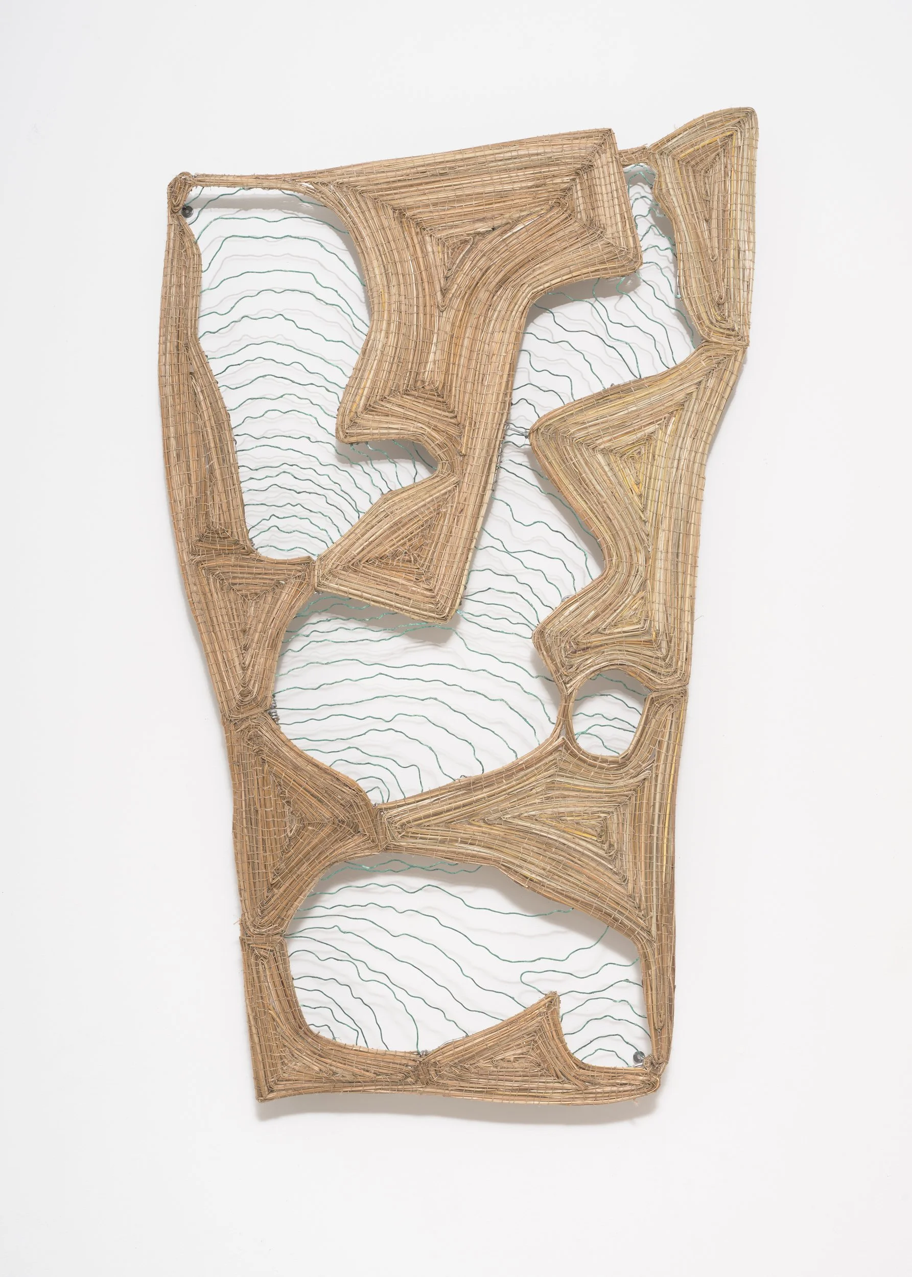 A wall art piece made of woven camel-coloured fibre shaped into abstract geometric patterns, mounted on a white wall.