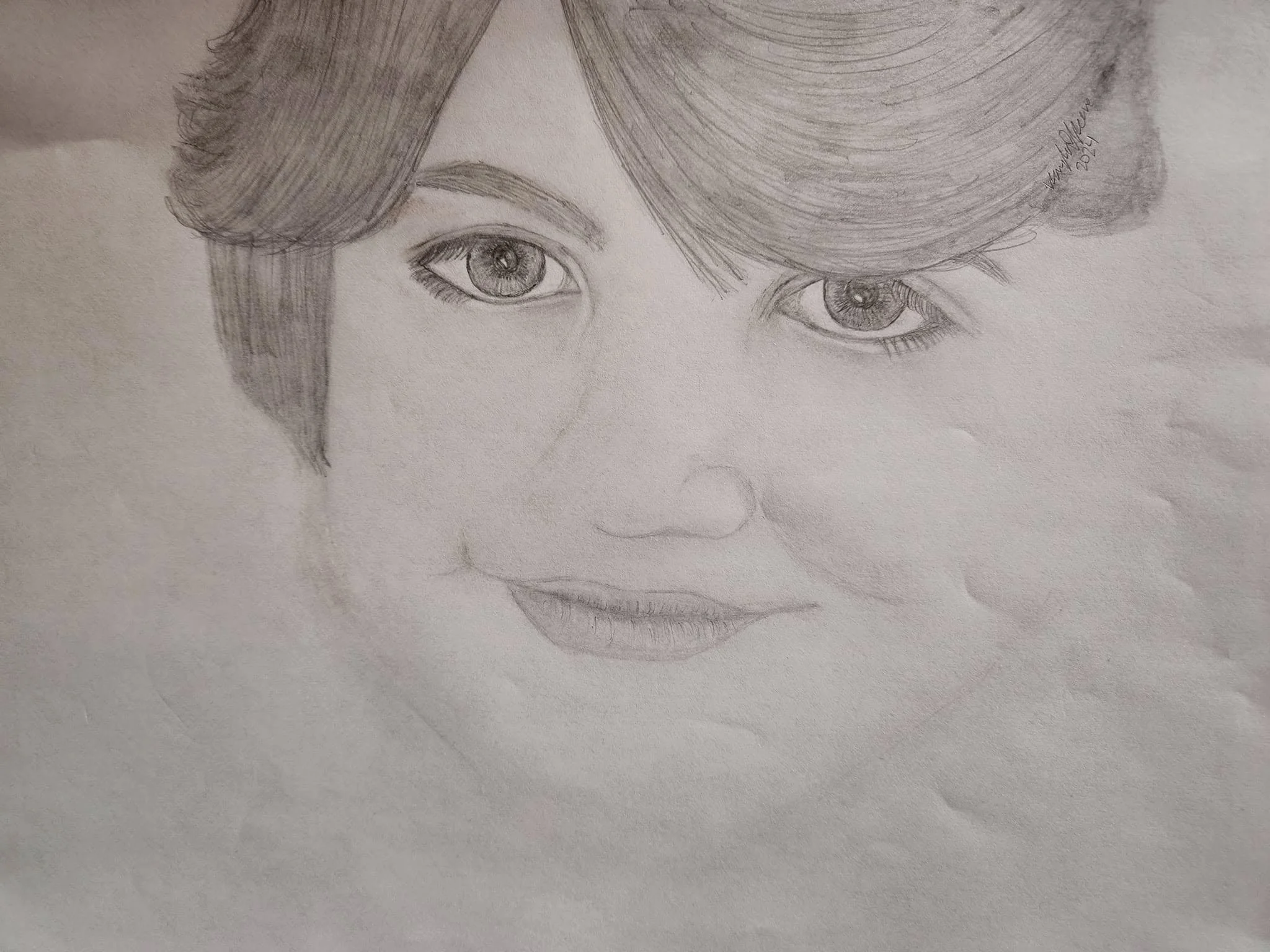 A detailed pencil sketch of a child's face, focusing on expressive eyes and hair.