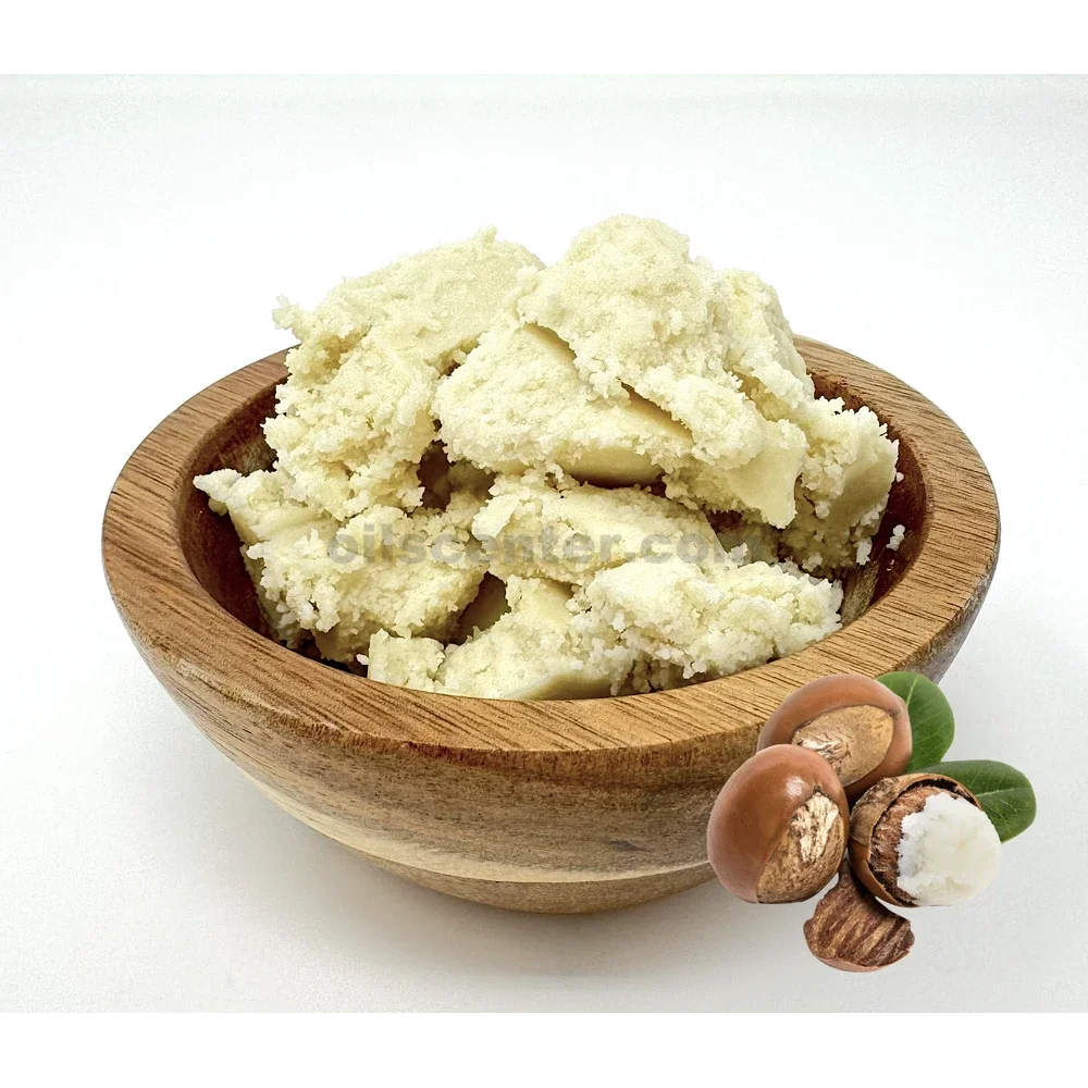 Bowl of mashed potatoes with a few raw mushrooms and green leaves on a white background.