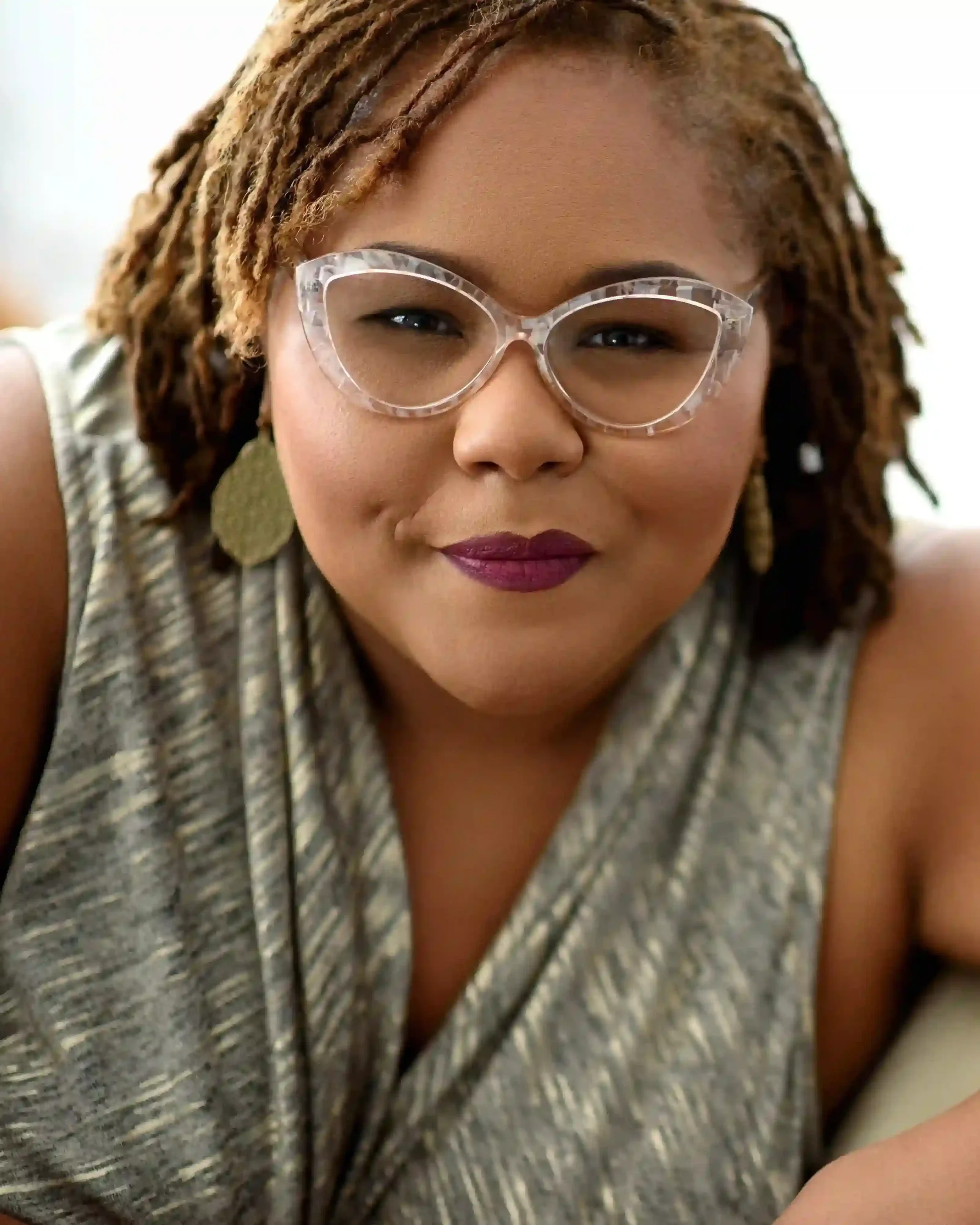Black woman wearing glasses and hair in short dreads