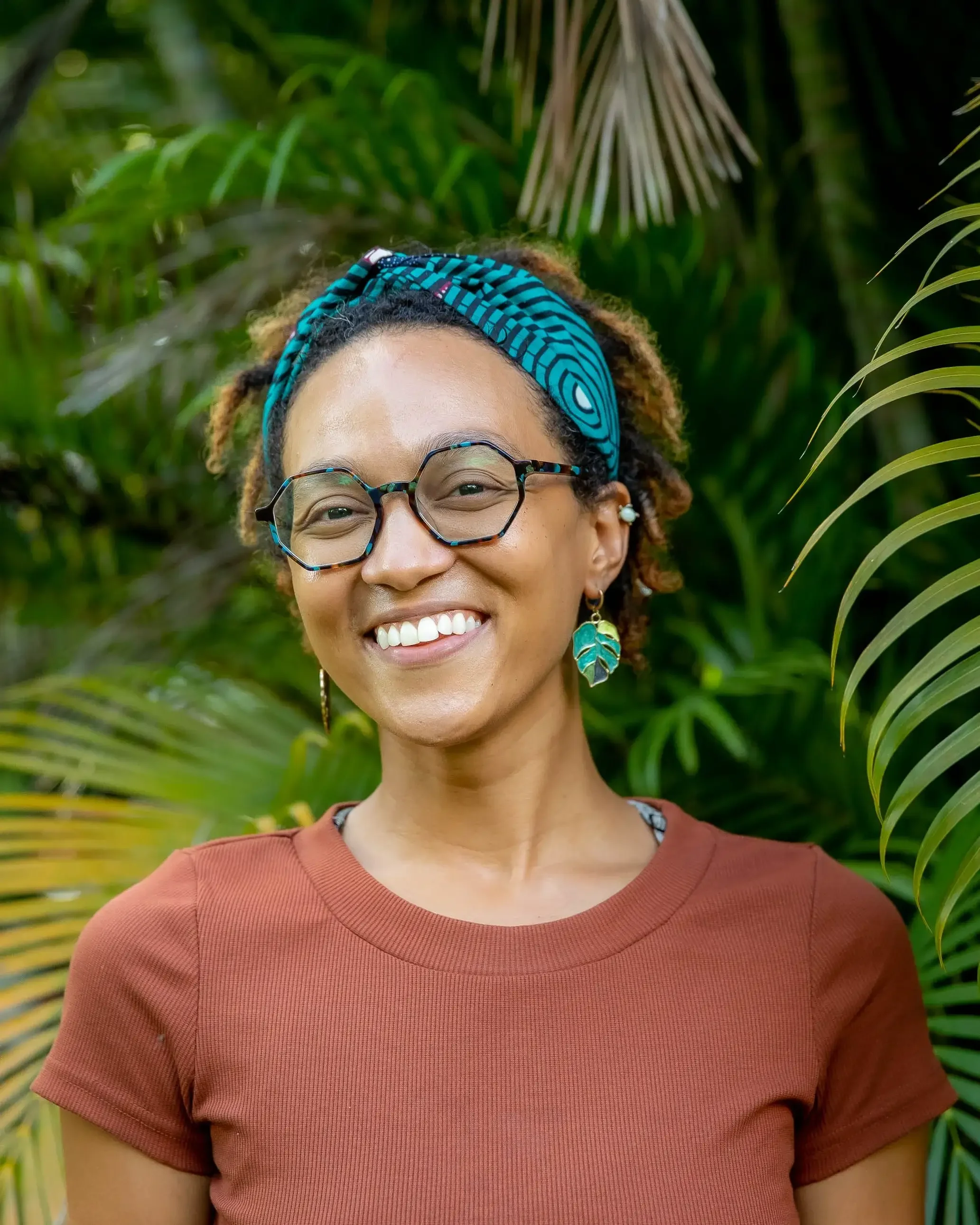 Black Woman wearing brown tank top and green headband