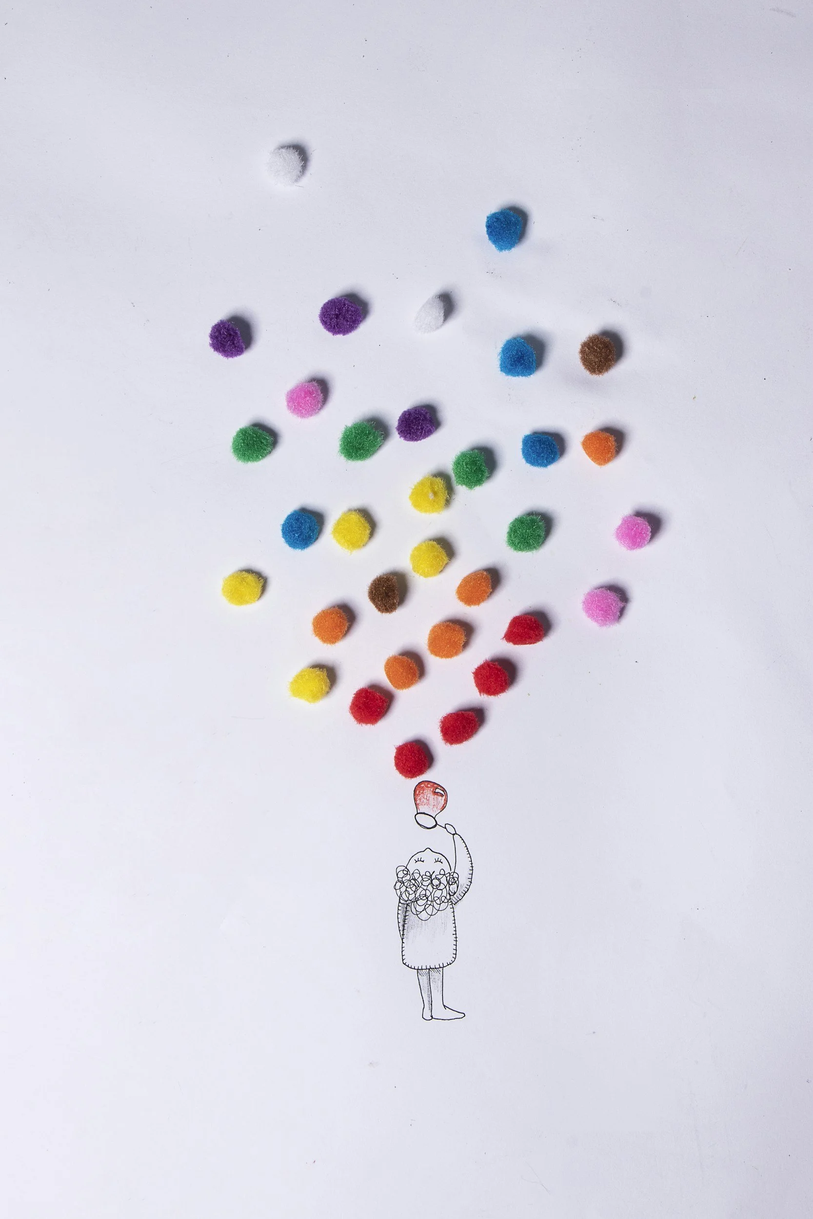 An animated girl holding a balloon, with colorful pom-poms floating upward, forming a balloon shape in the air.