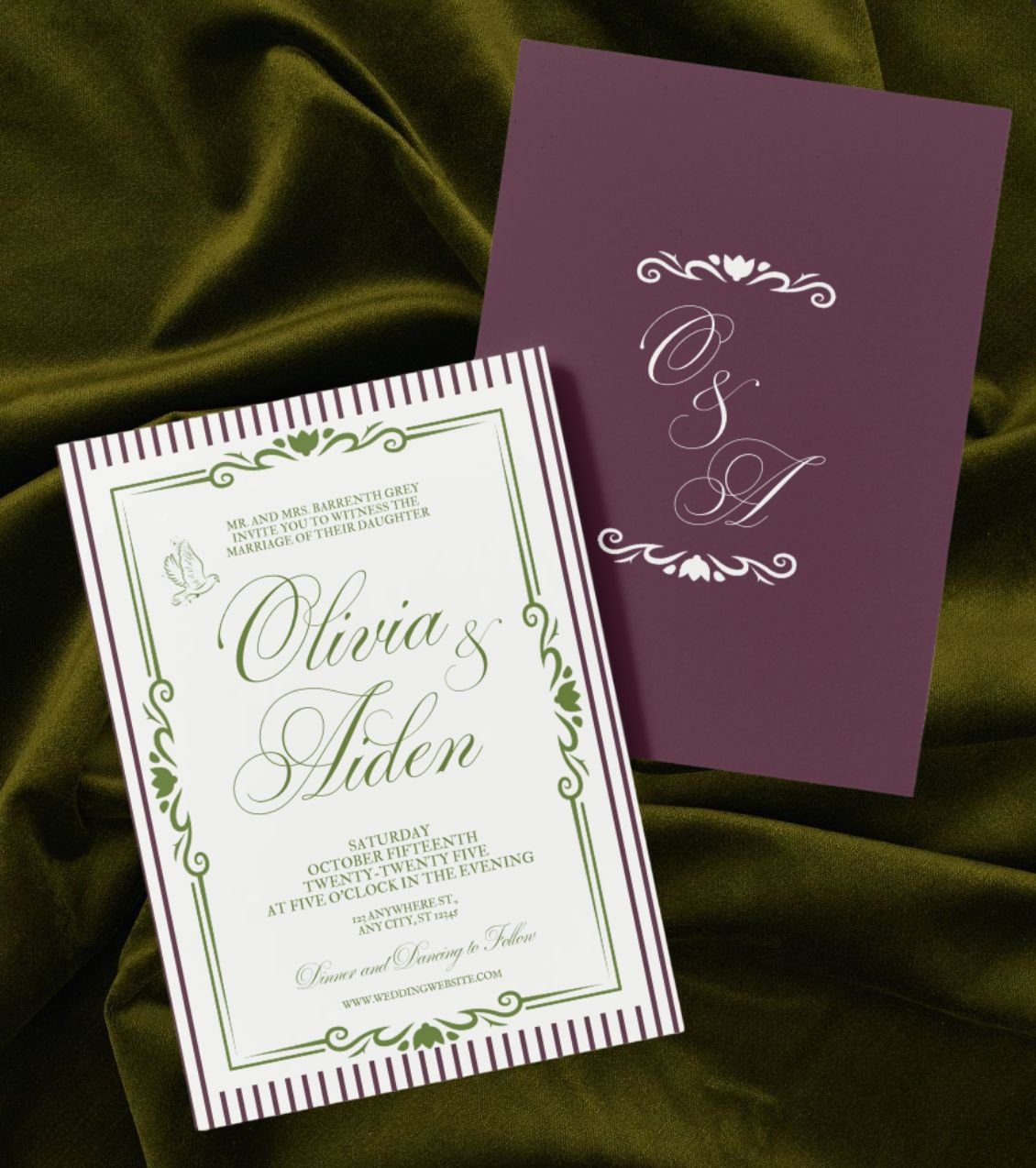 Wedding invitation card for Olivia and Aiden with decorative border and a purple RSVP card, placed on a green fabric background.