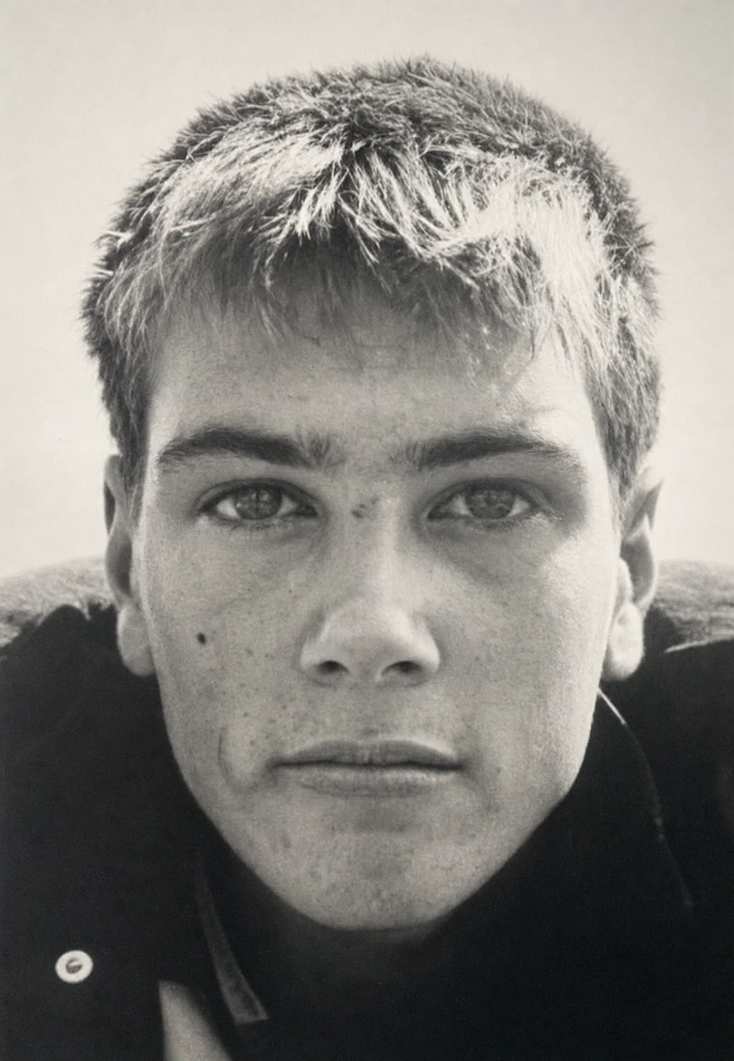 Black-and-white close-up portrait of a young Jack Dell looking directly at the camera.