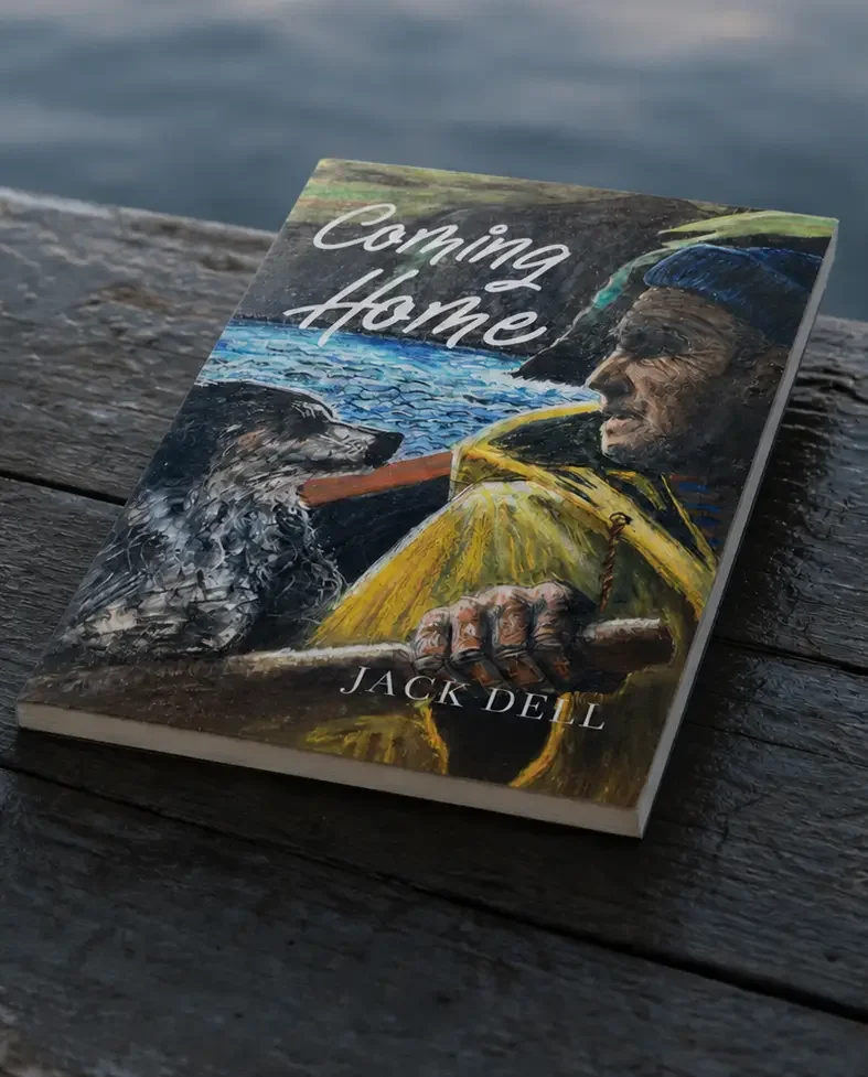 Coming Home by Jack Dell book pictured on a boat bench with ocean waves in the background.