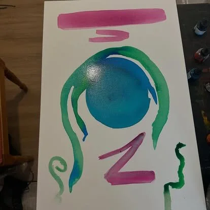 Colorful abstract painting with pink, blue, and green brushstrokes on paper.