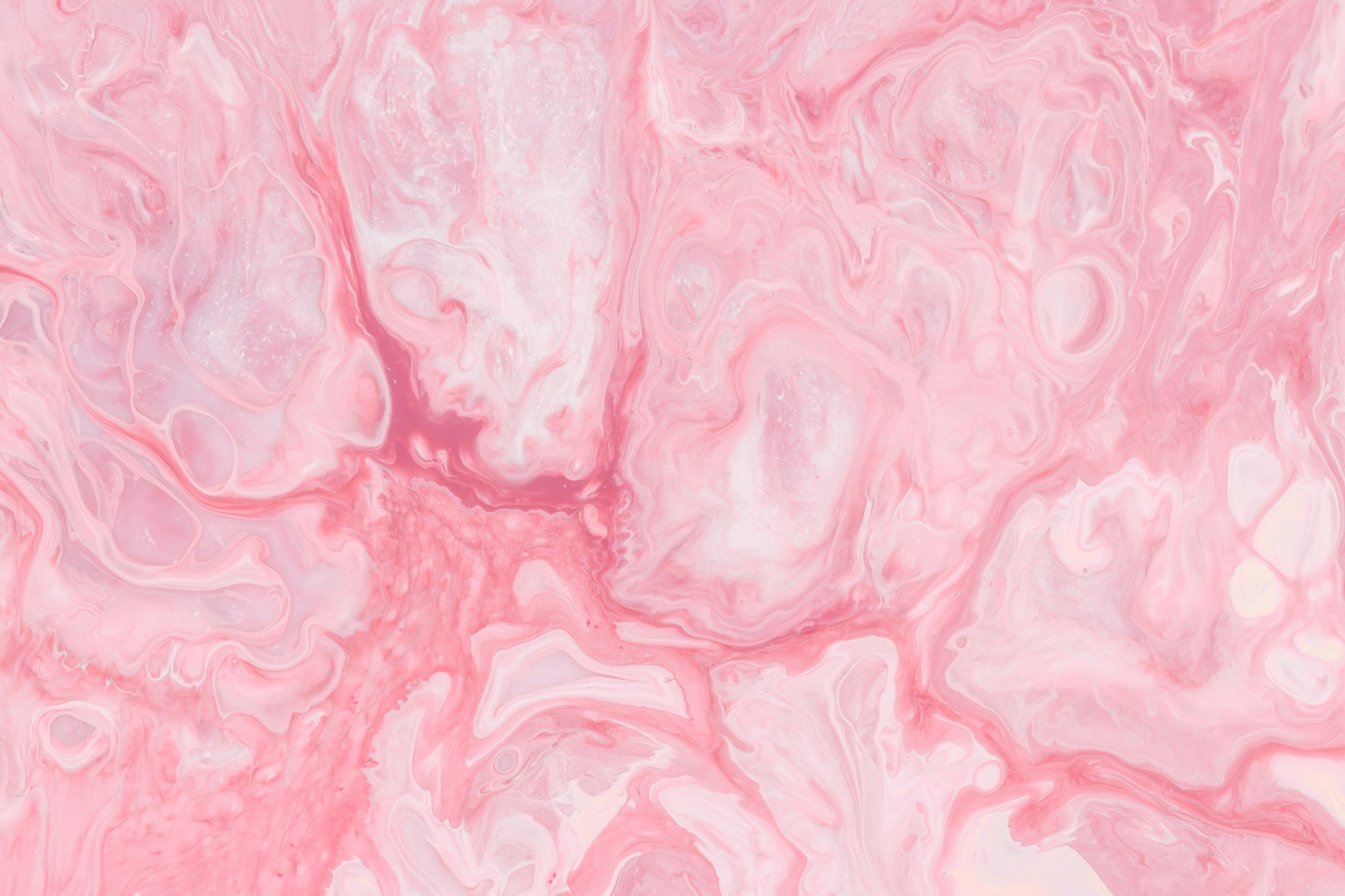 Pink and white marbled abstract background with swirling patterns.