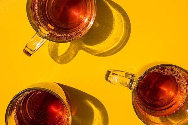 cups of tea on a yellow background