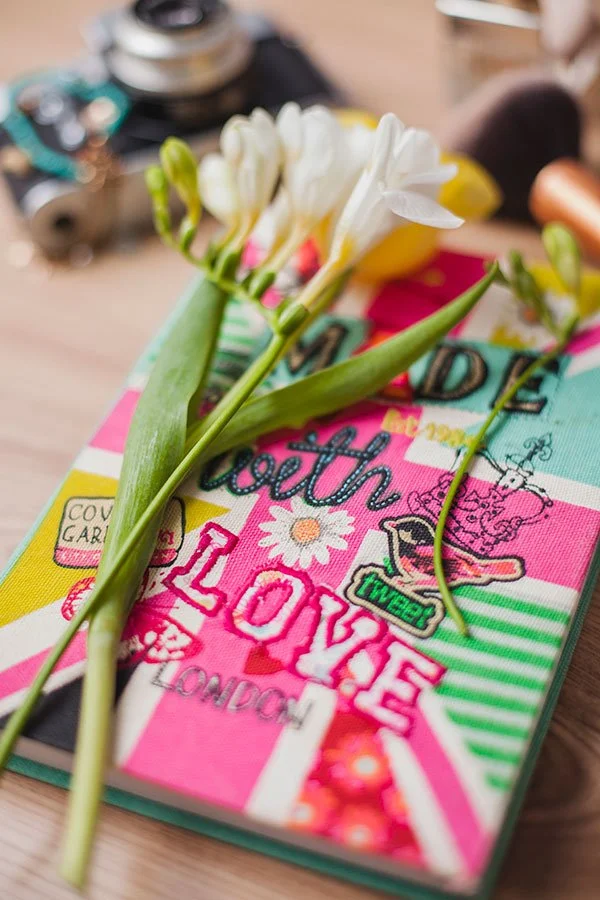 Flower on top of colourful notebook
