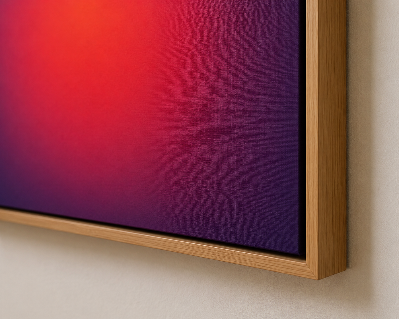 Close-up of a framed digital screen showing a gradient of red to purple colors, mounted on a beige wall.