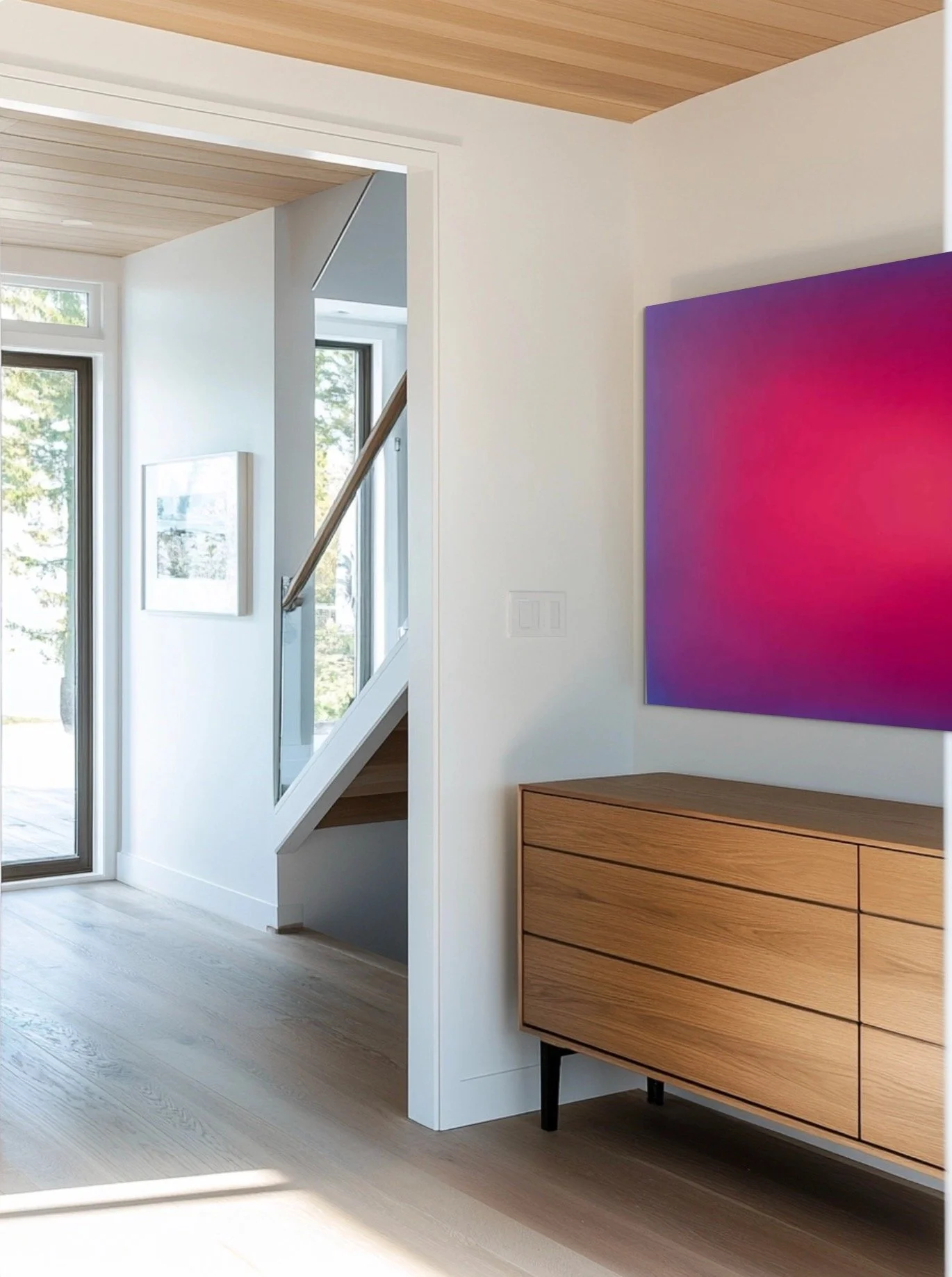 Interior of a modern house with wood and white walls, large windows, and a wooden cabinet.