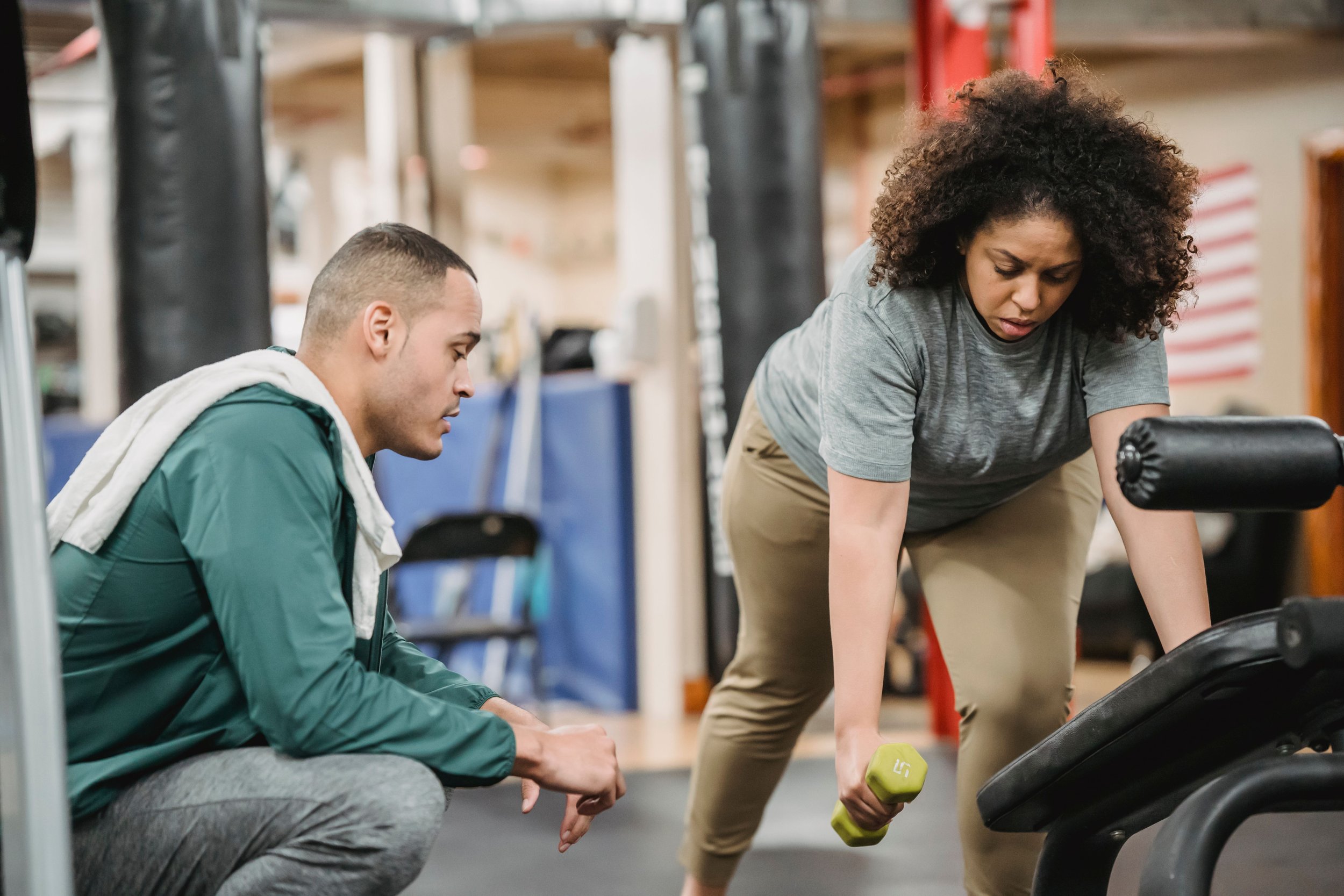 Personal trainer coaching a client during a strength-training exercise