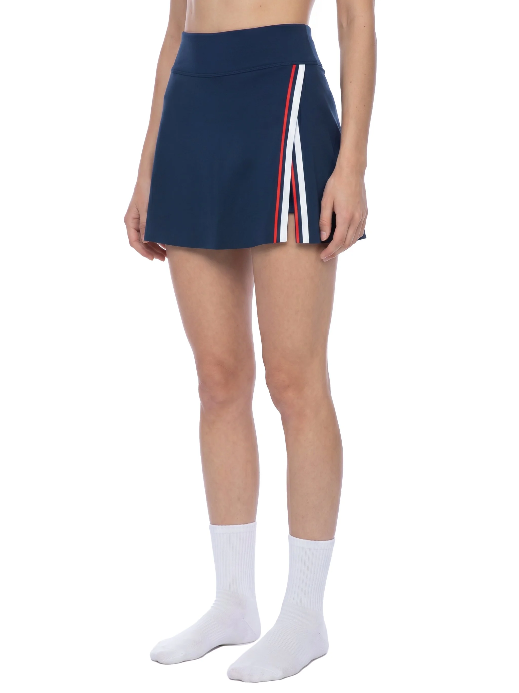 Model wearing navy athletic shorts with red, white and blue trim and white crew socks against a white background.