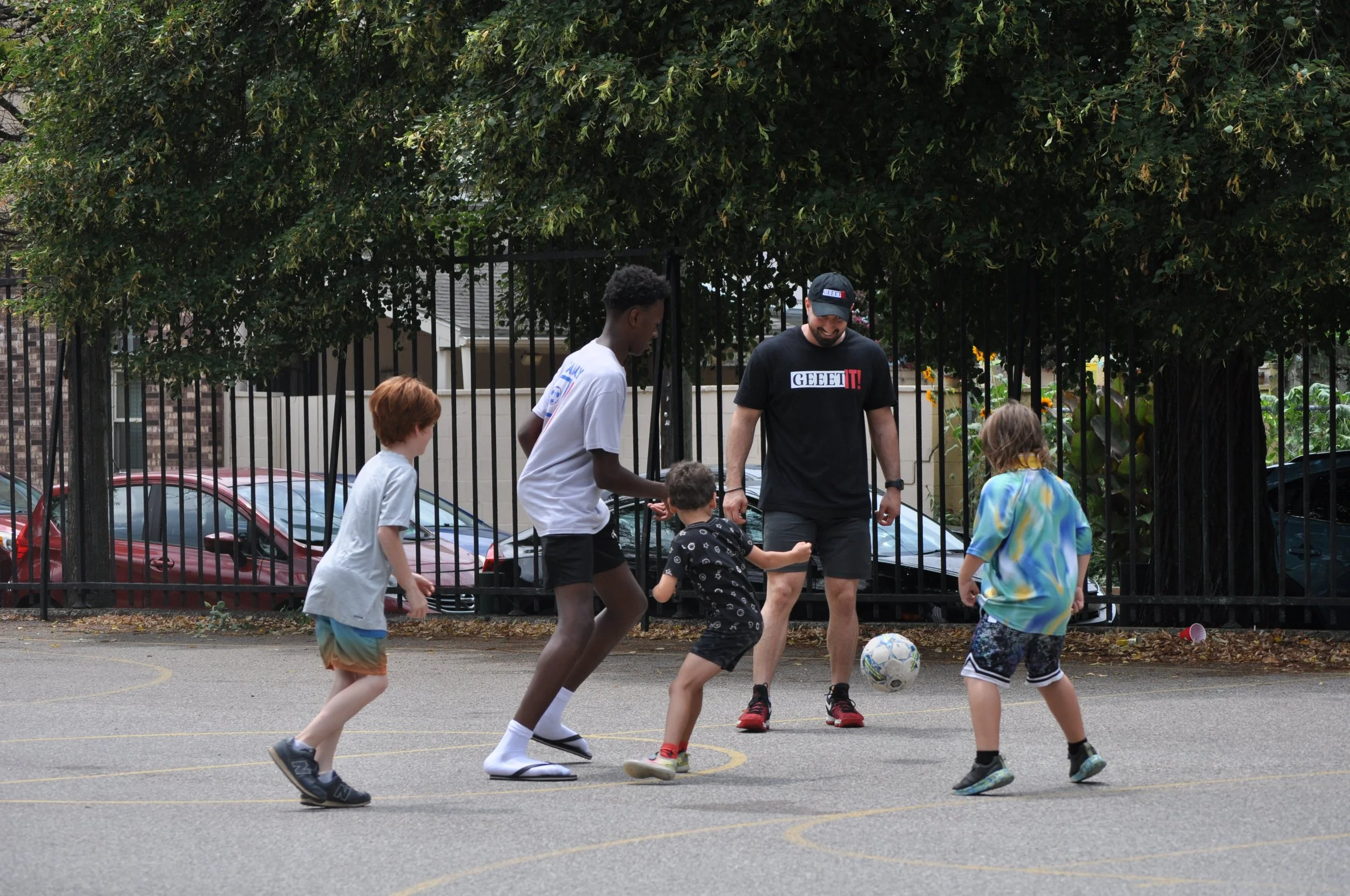 Children and a coach playing soccer during a Kids Geeet FIT! session at a Philadelphia recreation center