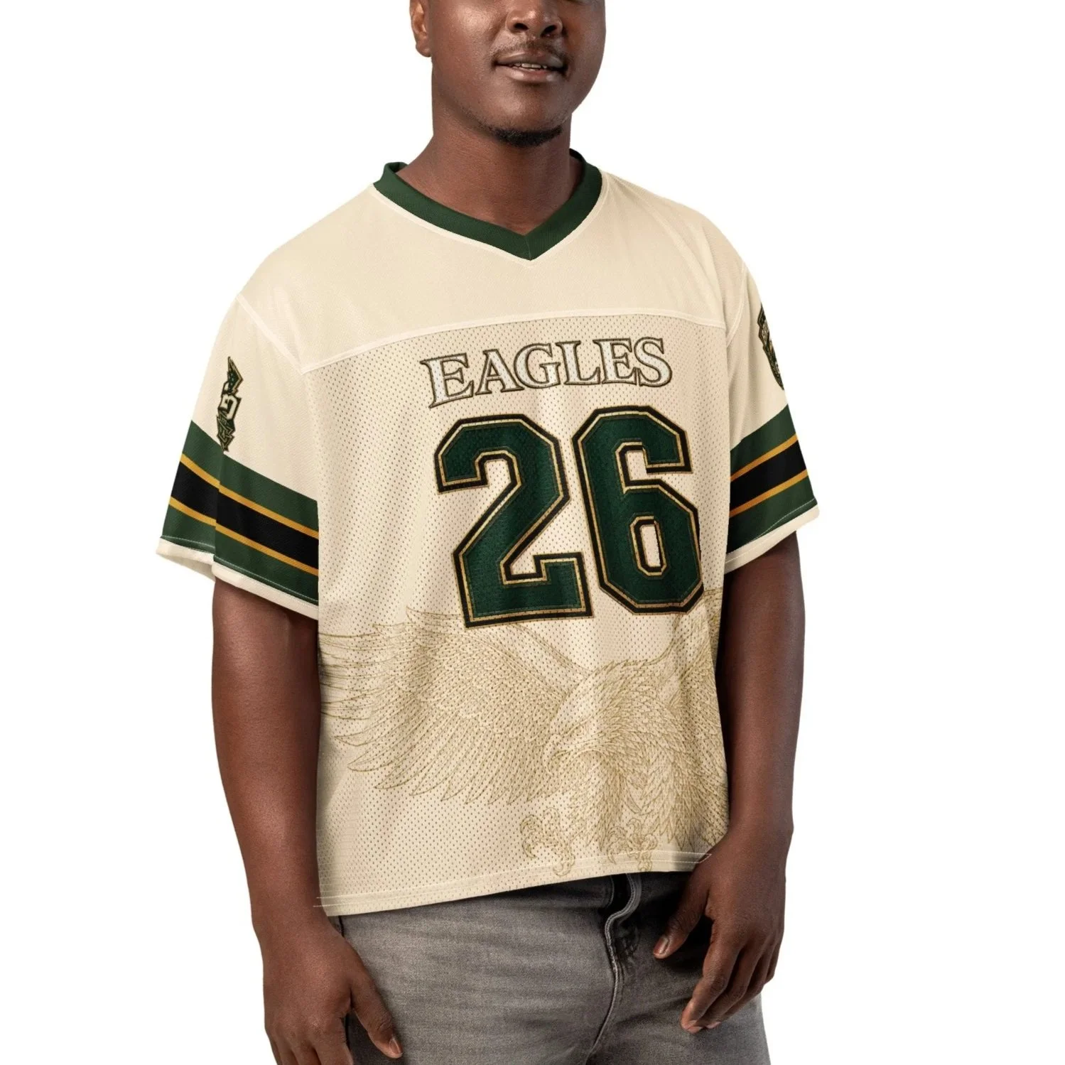 A man wearing a beige sports jersey with the text 'EAGLES' and the number 26 on it, with green and black accents, standing against a plain white background.