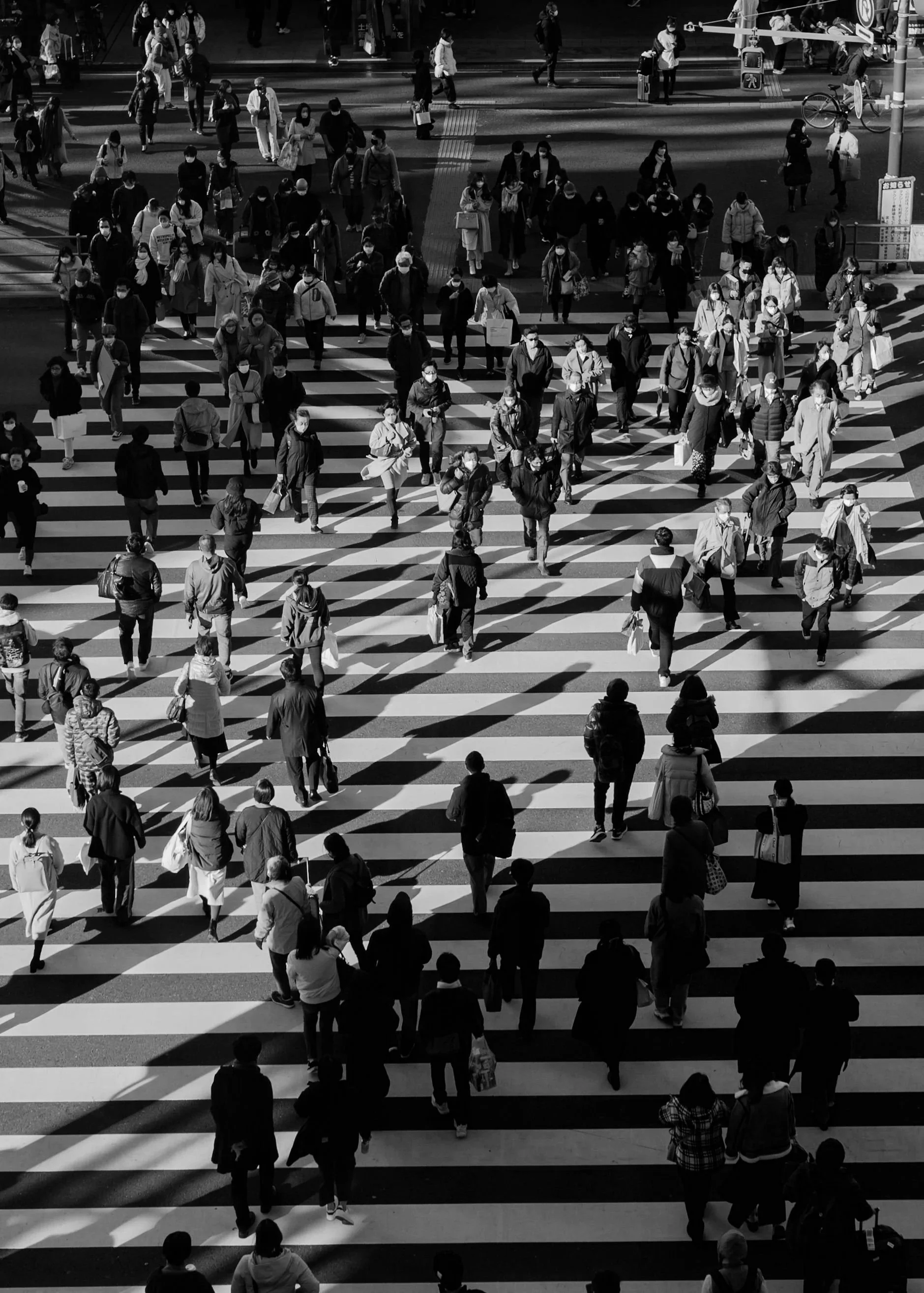 Aerial shot of a crowd walking across a crosswalk