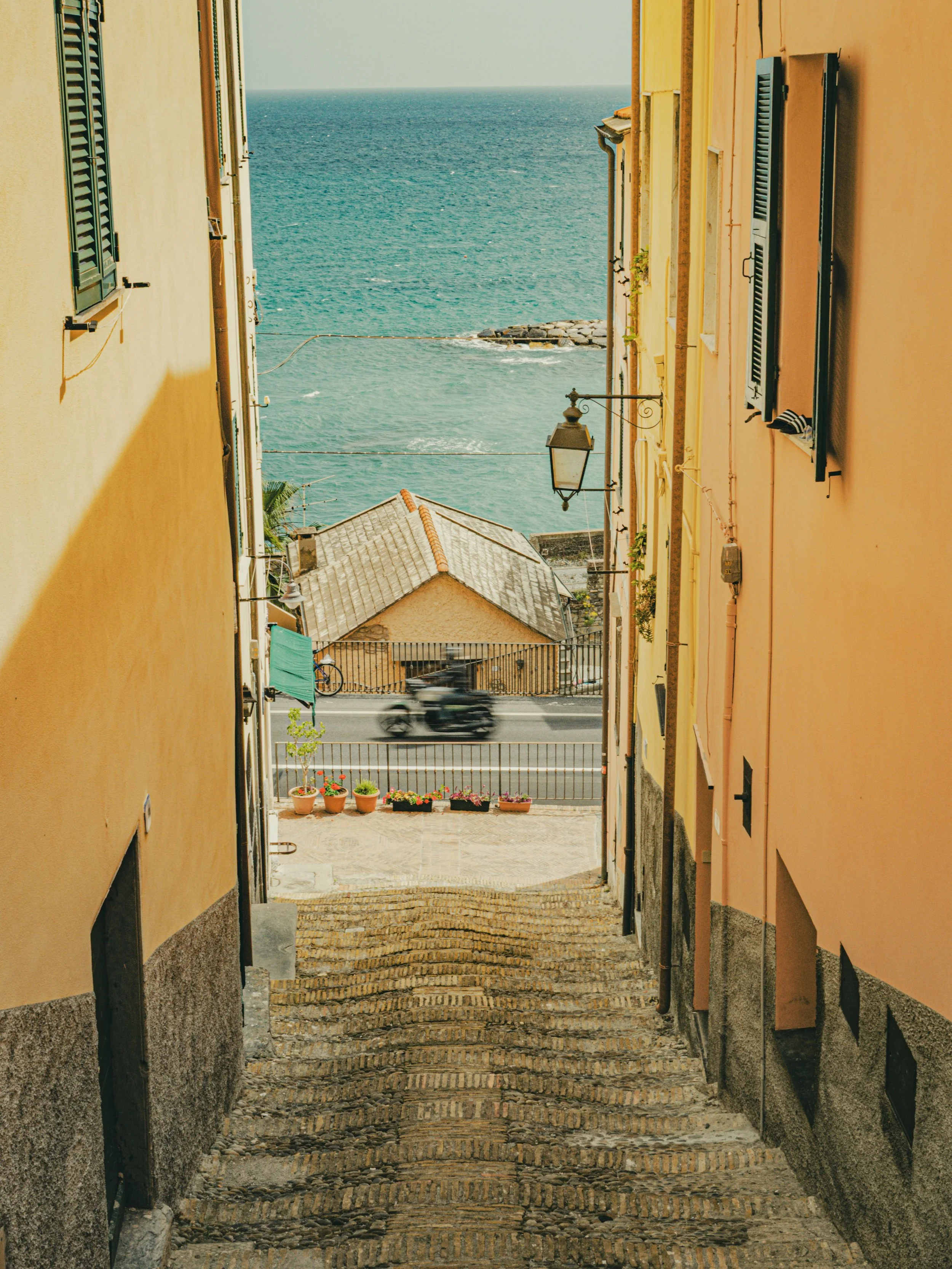 Stone steps leading through Ventimiglia Old Town toward the sea, a picturesque scene featured in every local guide to Ventimiglia.