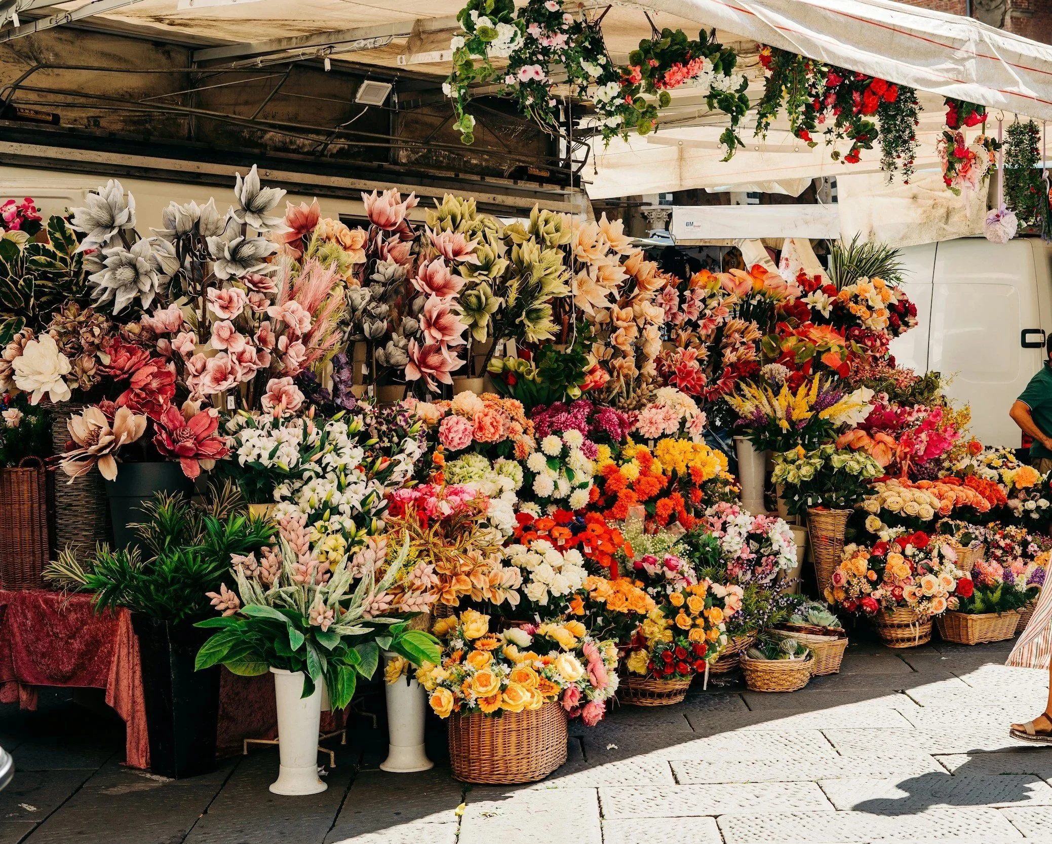 Colourful flower market in Liguria, showcasing local culture and one of the authentic experiences in what to see in Liguria.