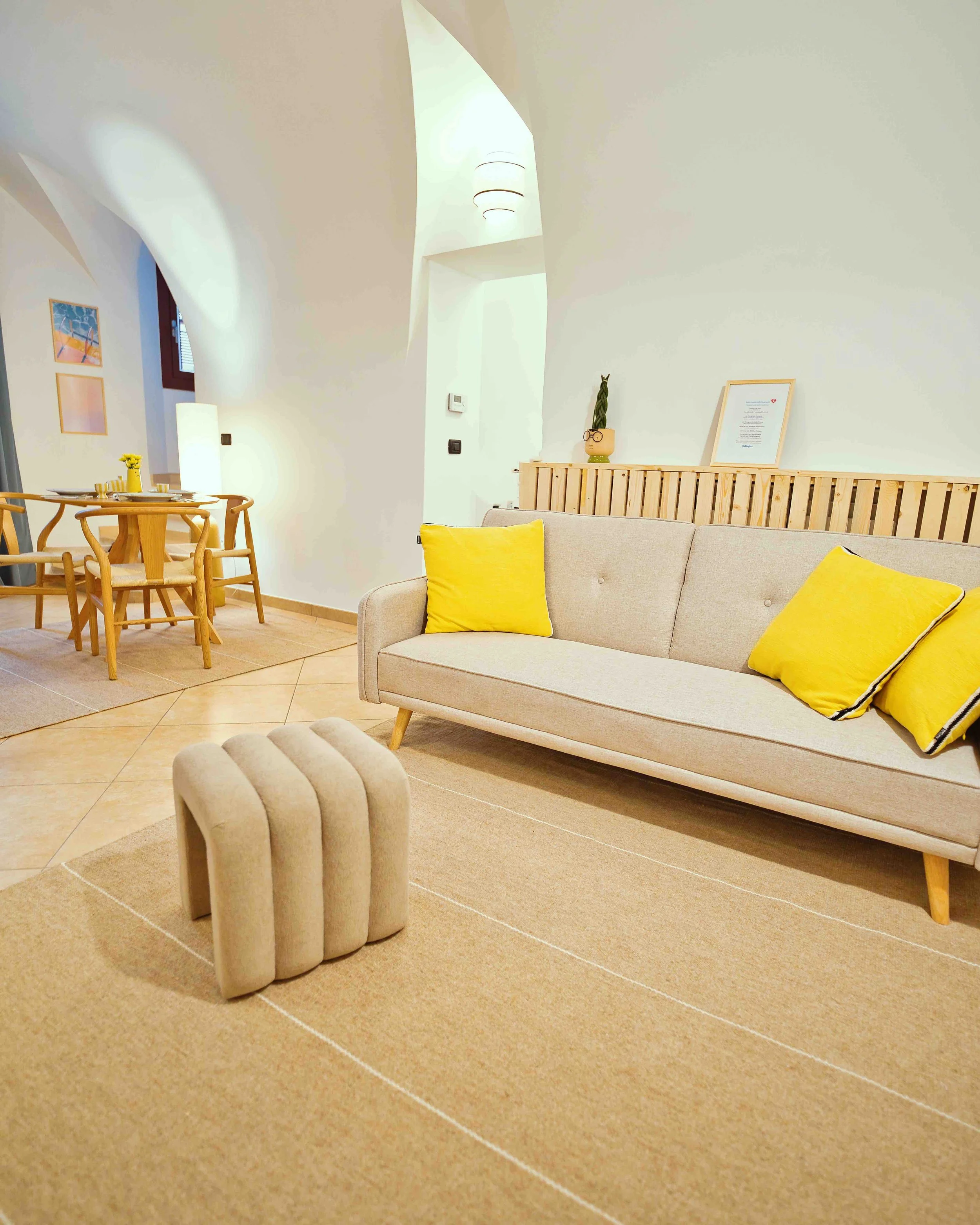 Spacious living room and dining area at Casa Thea by Babbaluci in Ventimiglia Alta, featuring a comfortable sofa, bright interiors and open-plan layout.