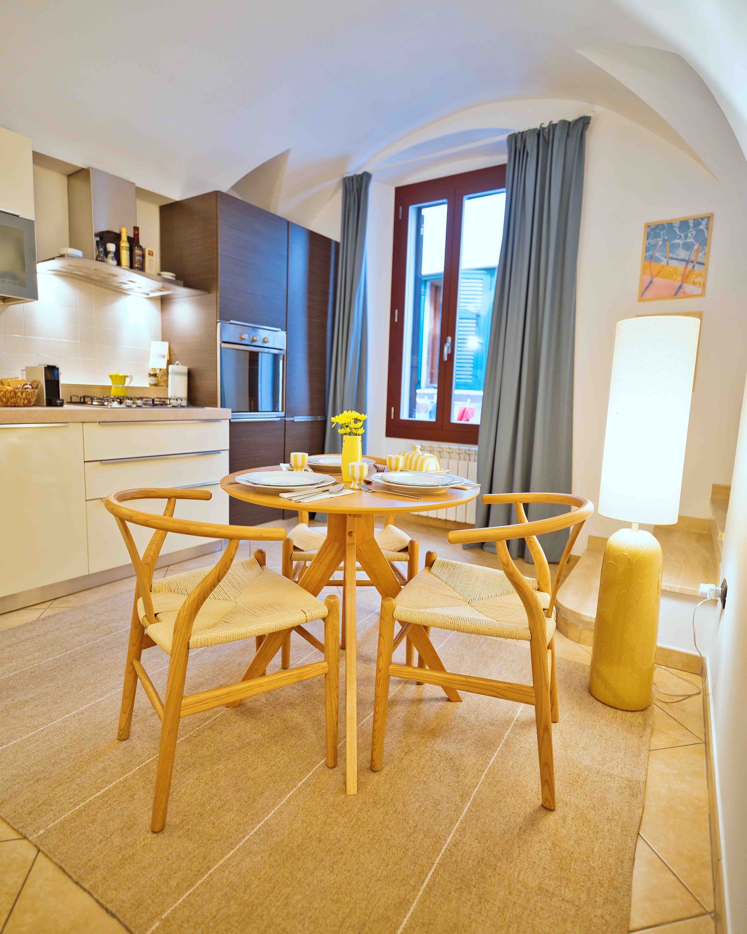 Bright open-plan kitchen and dining area at Casa Thea by Babbaluci in Ventimiglia Alta, featuring a fully equipped kitchen and cosy dining space.