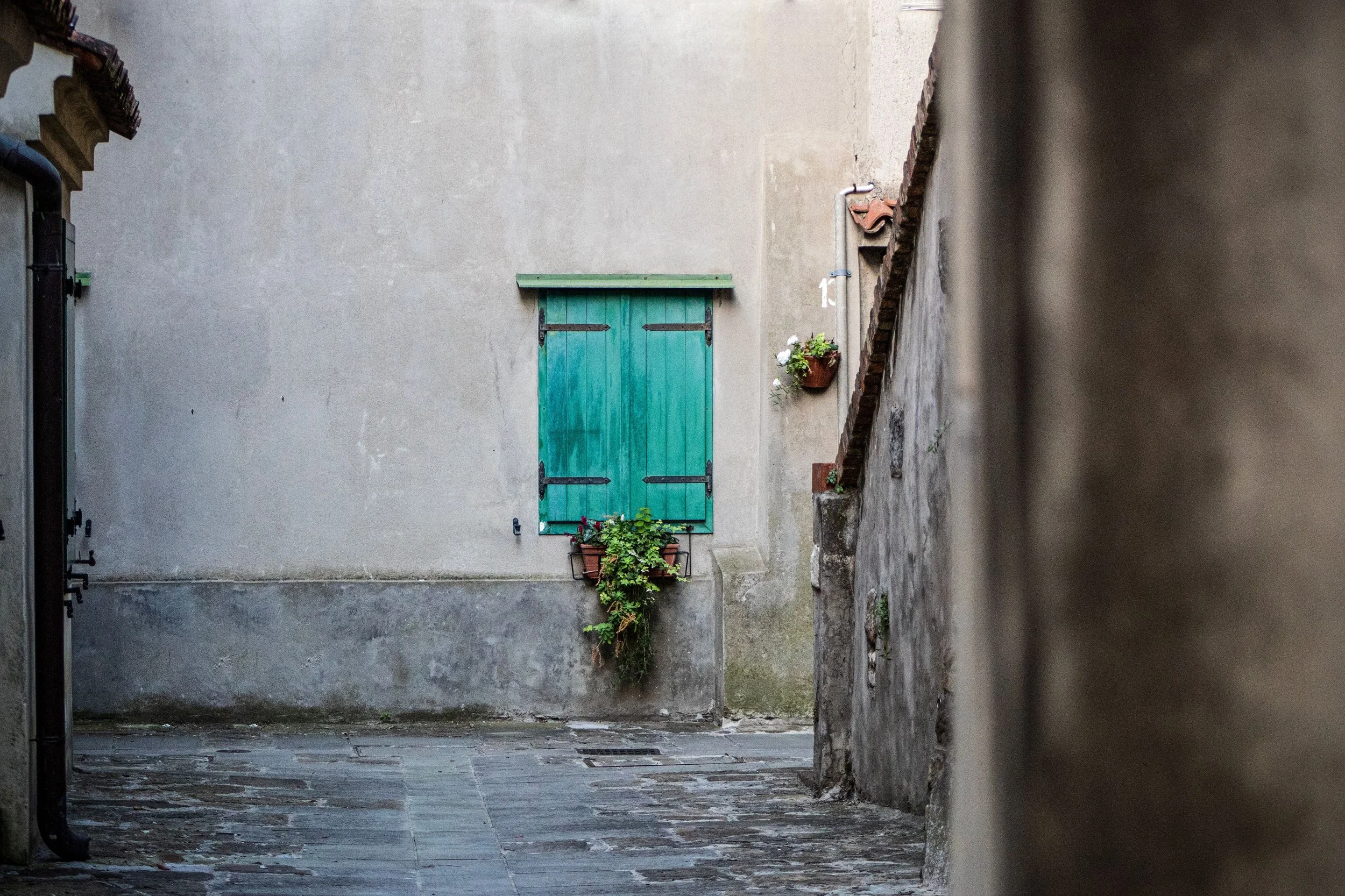 Quiet alley with a traditional green-shuttered window in Ventimiglia Old Town, one of the hidden corners highlighted in a local guide to Ventimiglia.