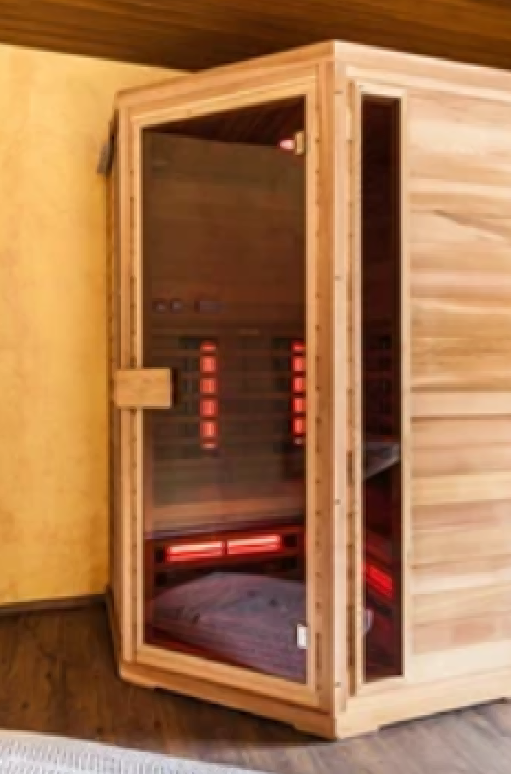 A wooden infrared sauna with a glass door and interior red heat lamps.