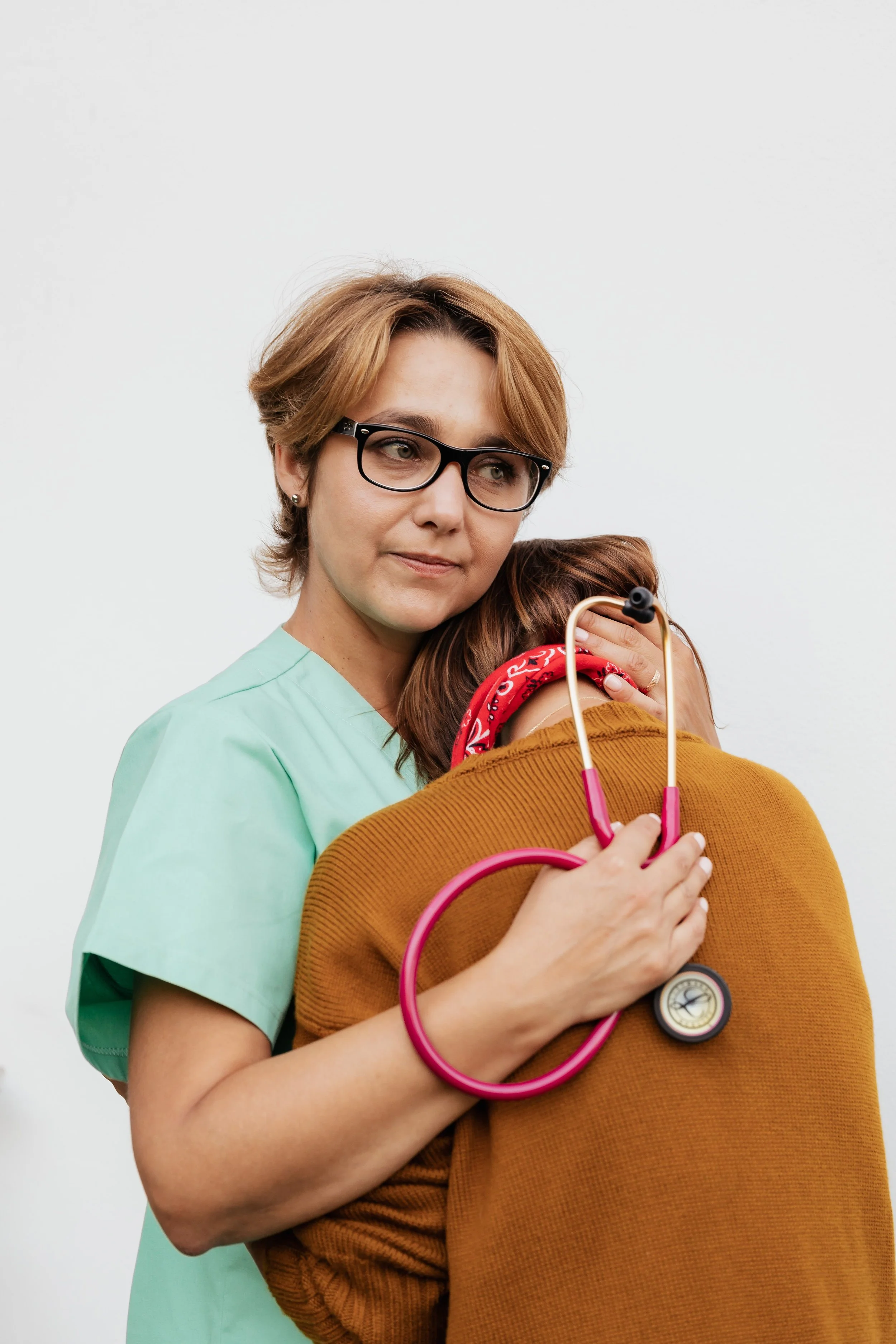 A nurse hugs a patient.