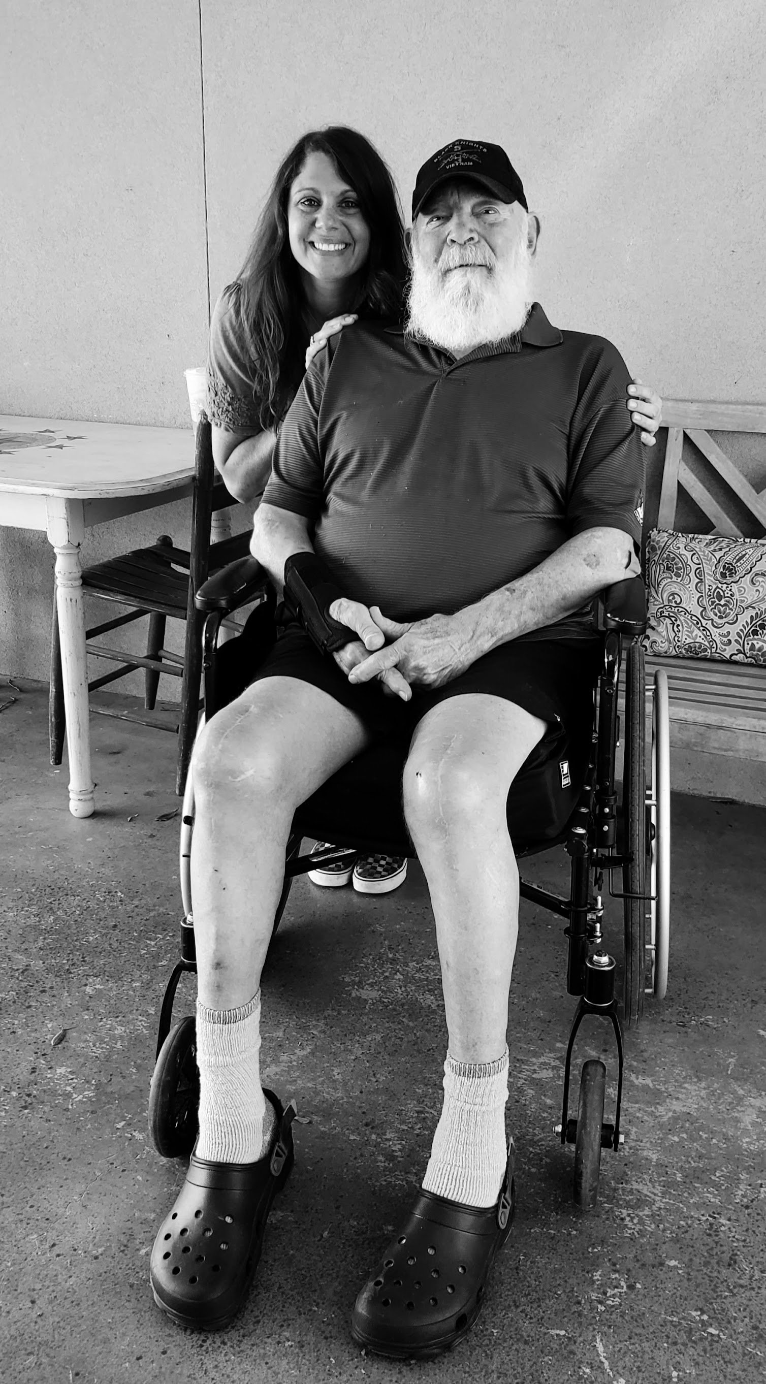 Patient Advocate Christi Jo poses with a wheelchair bound client.