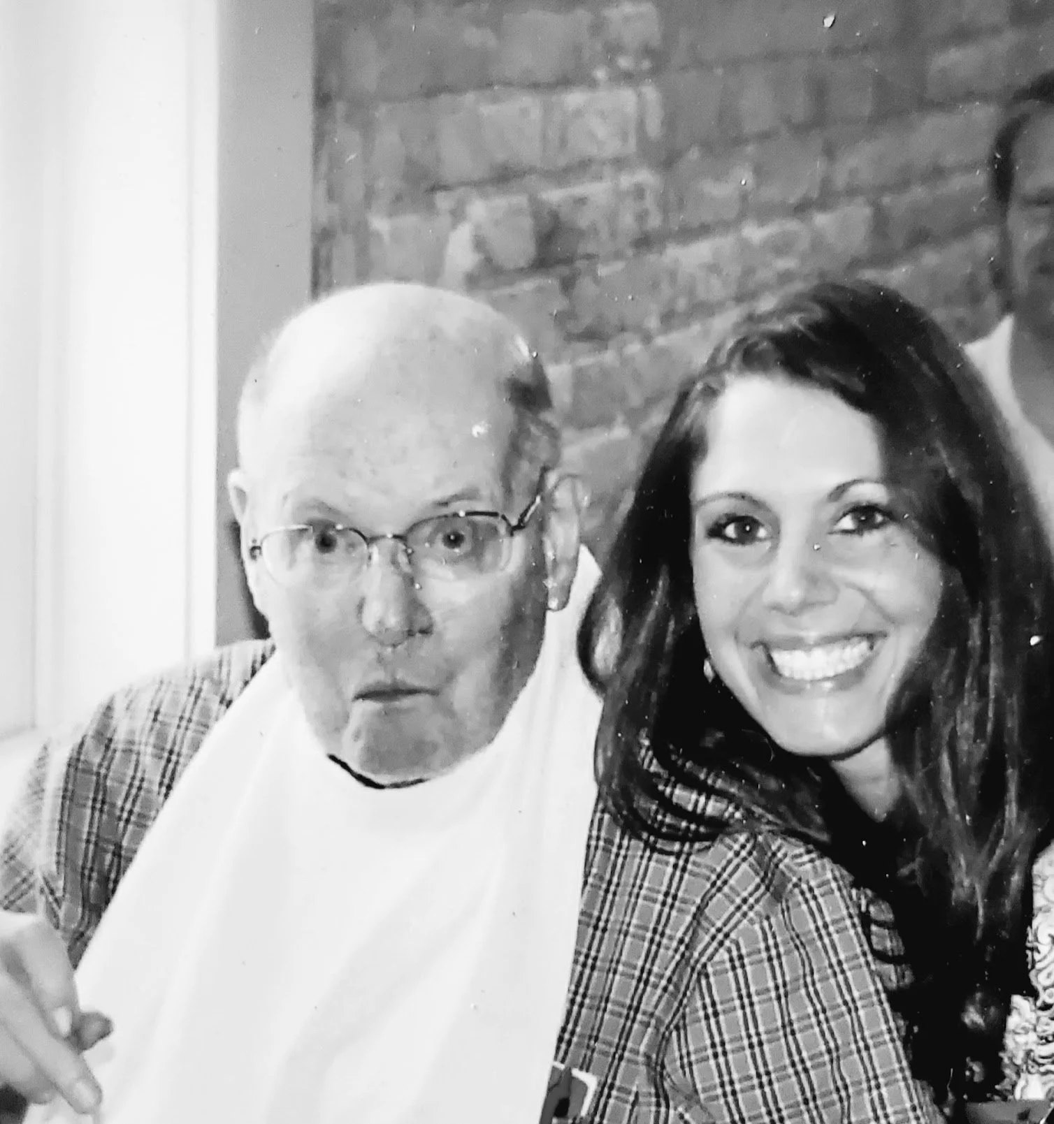 Patient Advocate CJ poses with an older client.