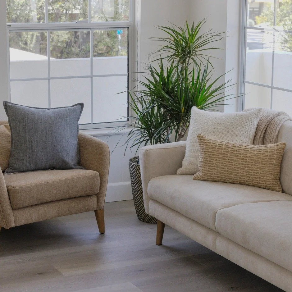 A beautiful psychologist office of Dr. Elise Bisbee, showing therapy sofa and armchair for clients