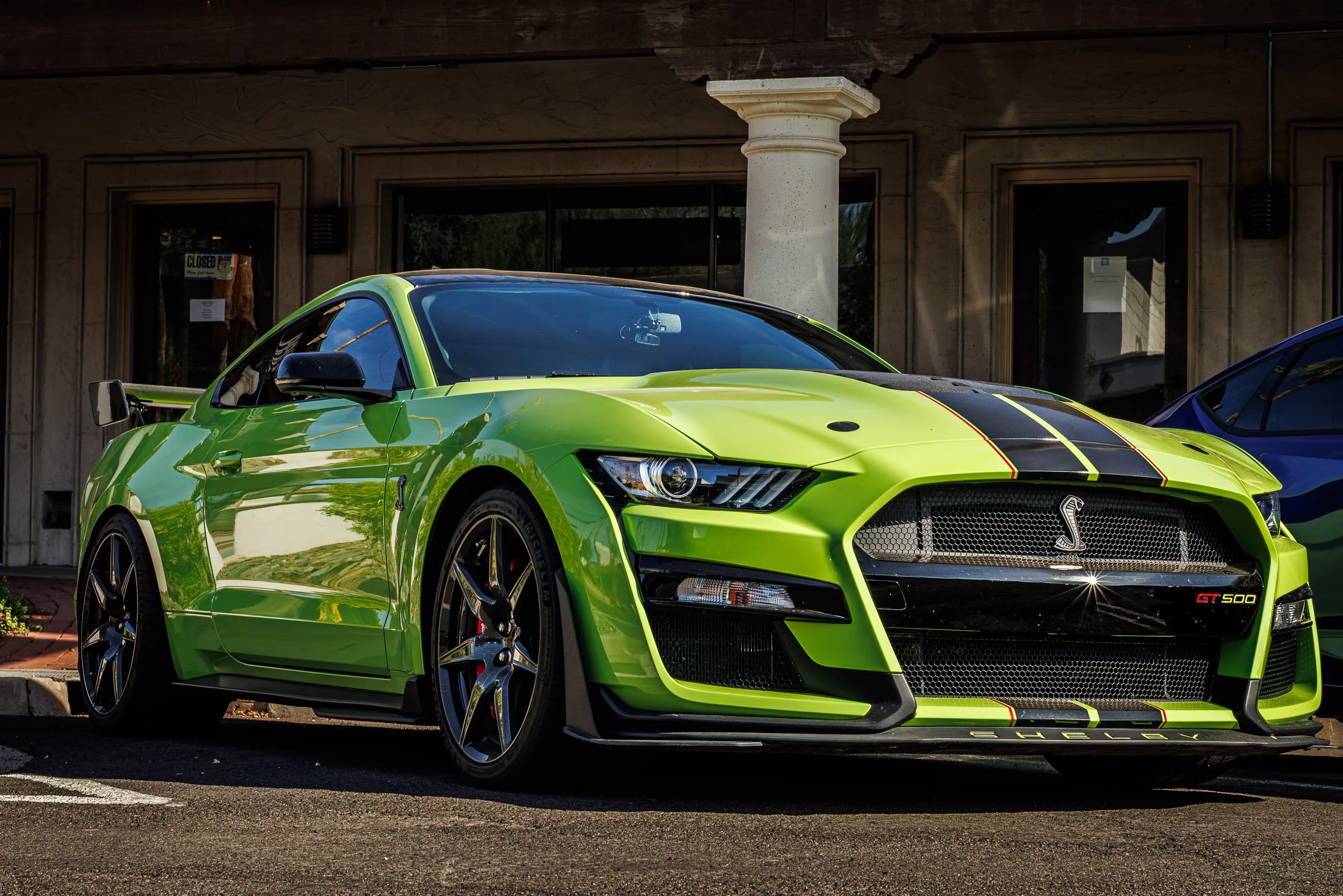 High-performance car photography showcasing a bright lime green Ford Shelby Mustang GT500 with black racing stripes in Scottsdale, Arizona, captured by Curtis from Gasoline and Dopamine Photography.