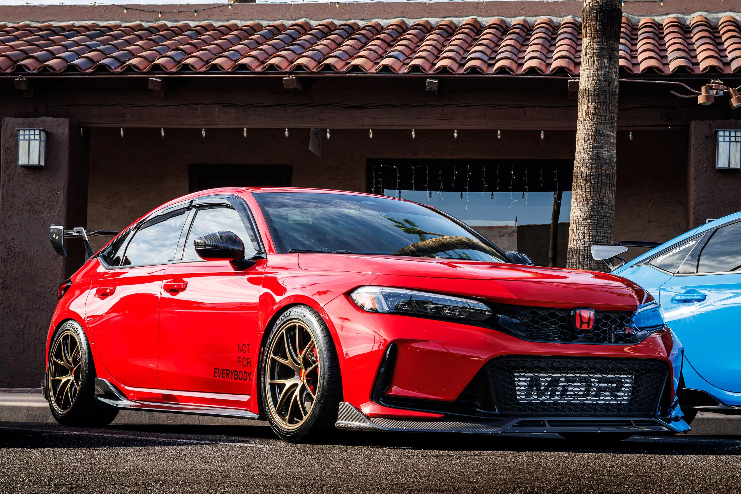 Street car photography of a heavily modified, bright red Honda Civic Type R featuring bronze aftermarket wheels, carbon fiber aero, and an exposed MDR intercooler in Scottsdale, Arizona, photographed by Curtis from Gasoline and Dopamine.