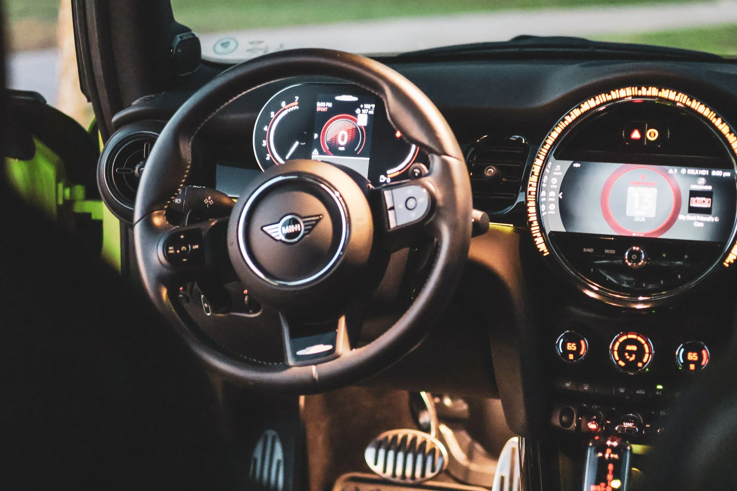 Cinematic interior car photography featuring the steering wheel, illuminated digital dashboard, and ambient lighting of a Mini Cooper JCW, edited with a heavy film grain style in Gilbert, Arizona, captured by Curtis from Gasoline and Dopamine.