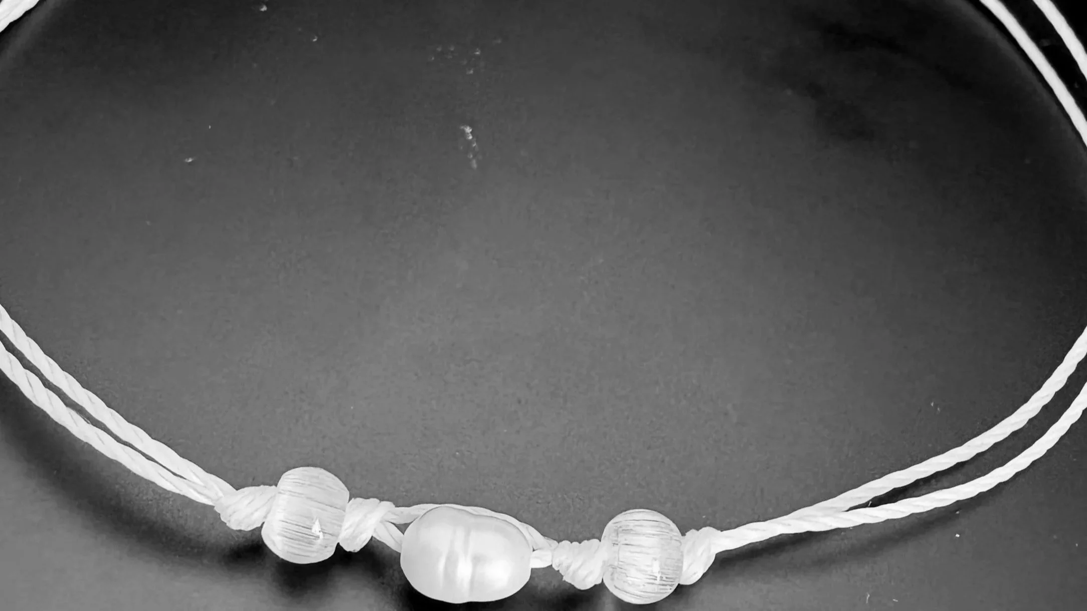 Bracelet with freshwater rice pearl  and two clear beads on either side representing the imperfect individual loved by divine parents