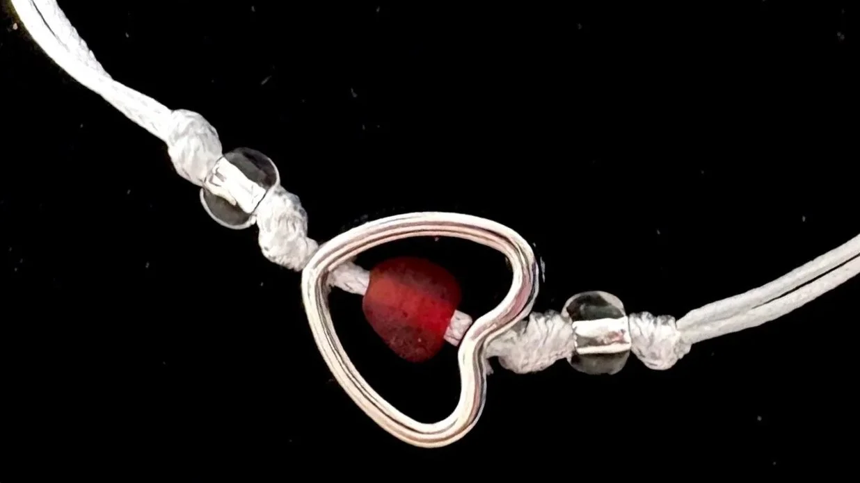 Bracelet with red glass bead inside of a heart symbolizing the Atonement and Christ's Love for Us