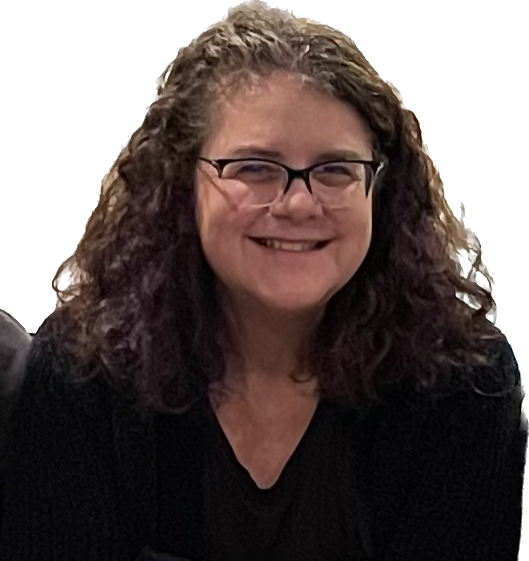 A woman with curly hair and glasses smiling at the camera.