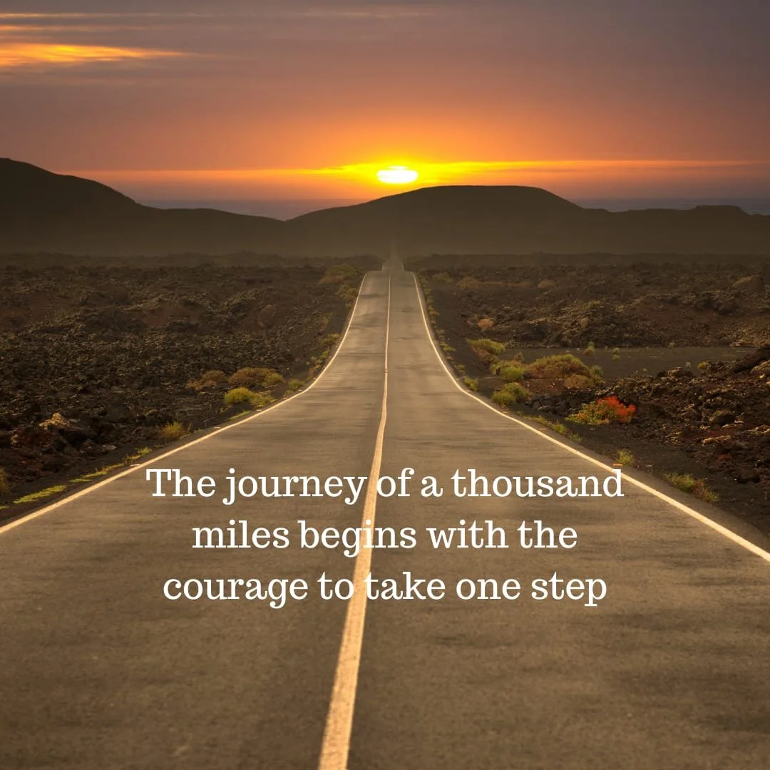 A straight road extending towards the horizon in a desert landscape during sunset, with hills in the background. Overlaid text says, 'The journey of a thousand miles begins with the courage to take one step.'