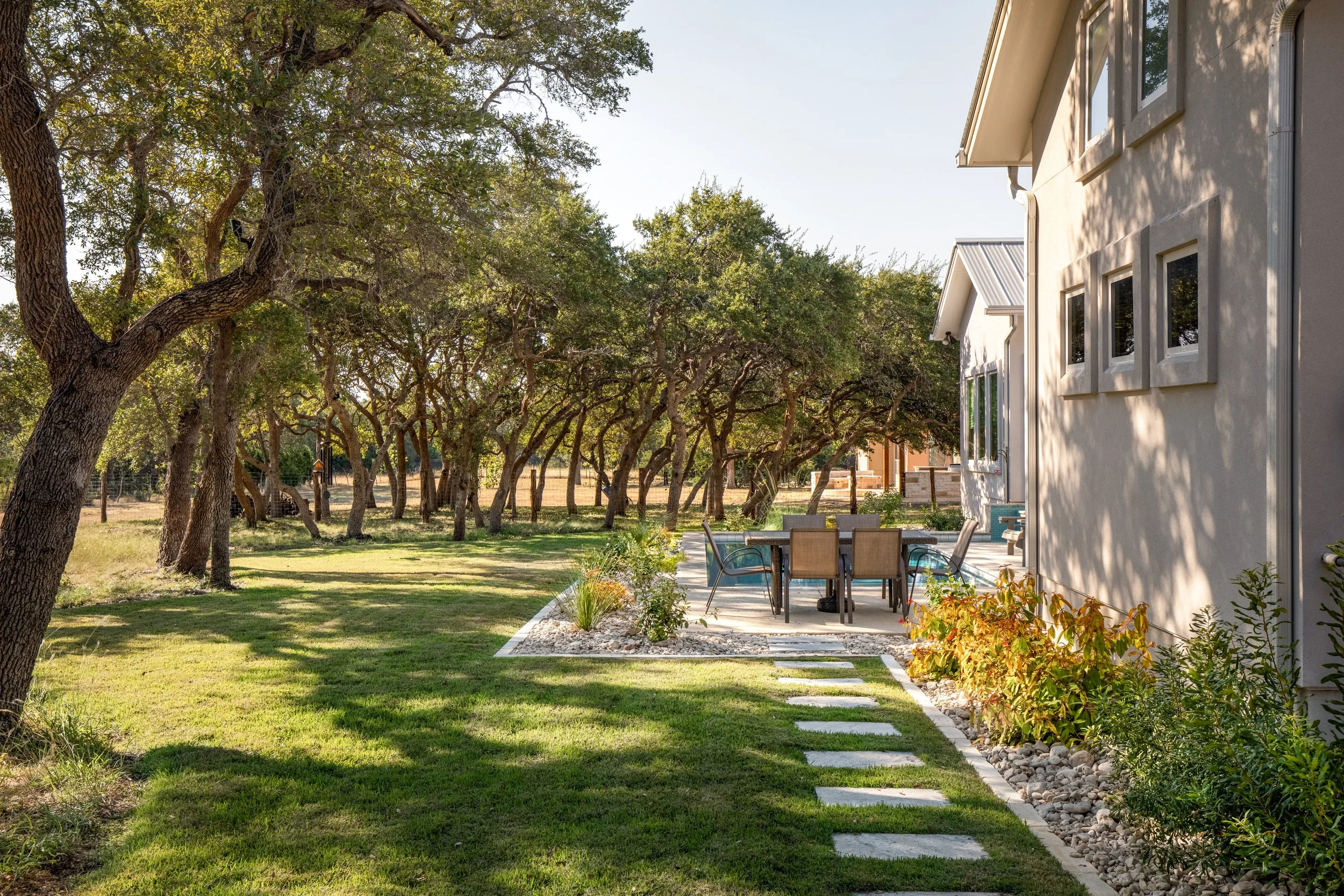 Tree-lined walkway and lawn on a Hill Country property