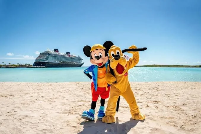 Mickey Mouse and Pluto at the beach with a cruise ship in the background.