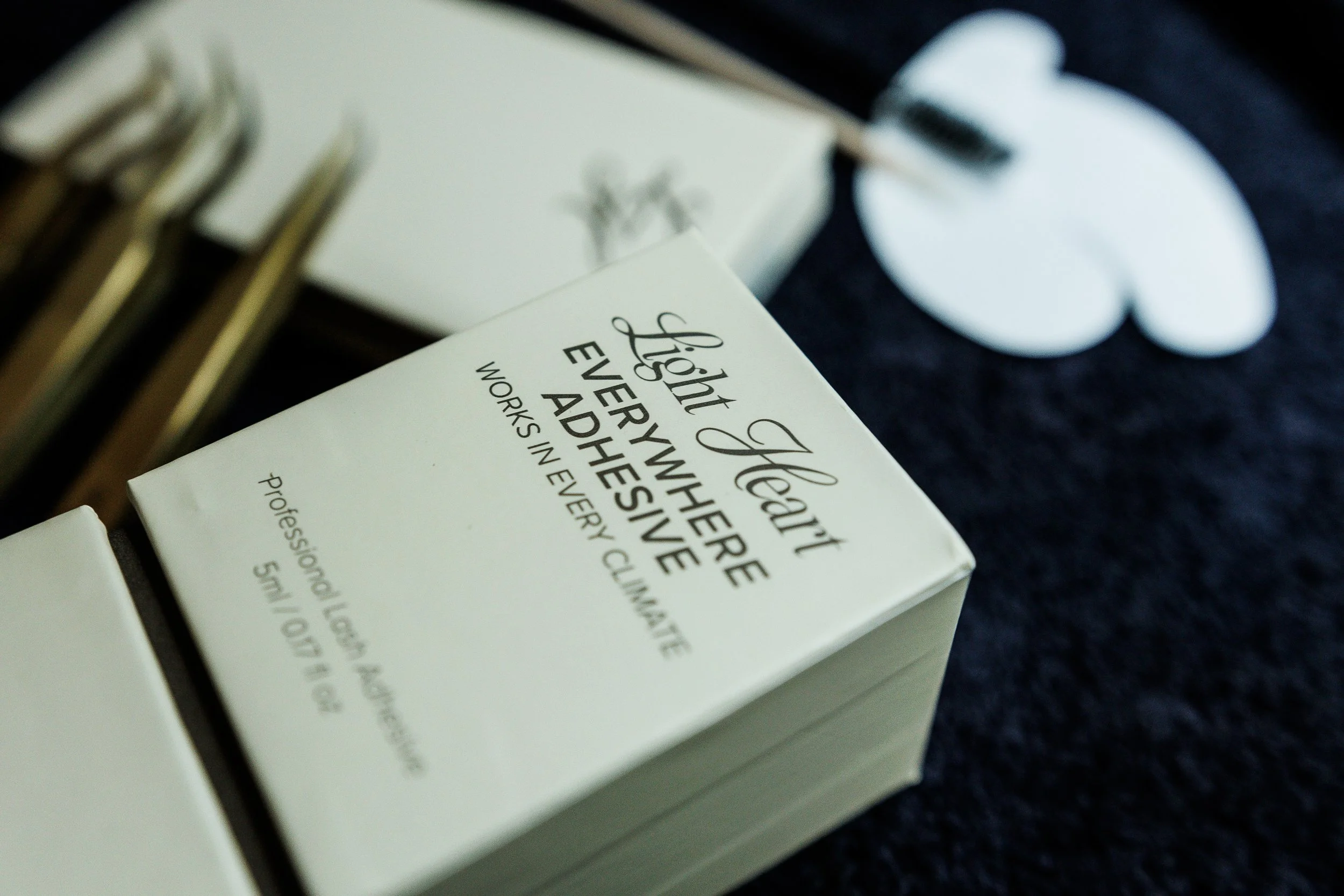 Close-up of a white box with black text that reads 'Fight Therapy and' followed by smaller, less readable text. The box is on a dark surface, and part of a white object, possibly a mouse, is visible in the background.