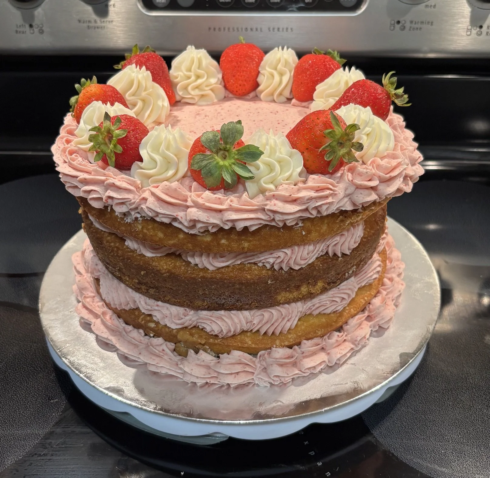 8 inch 3 layer Vanilla cake with Strawberry buttercream filled with Strawberry compote