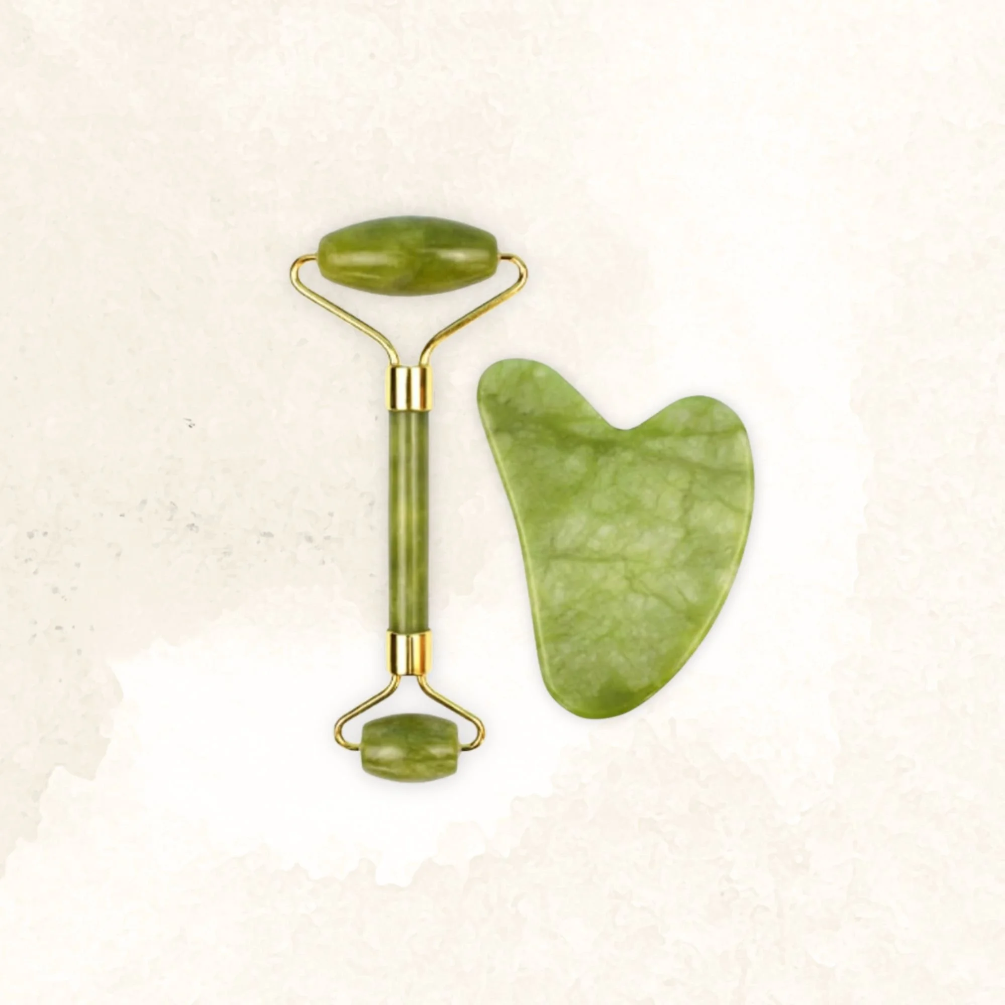 Green facial roller and gua sha stone on a white background.