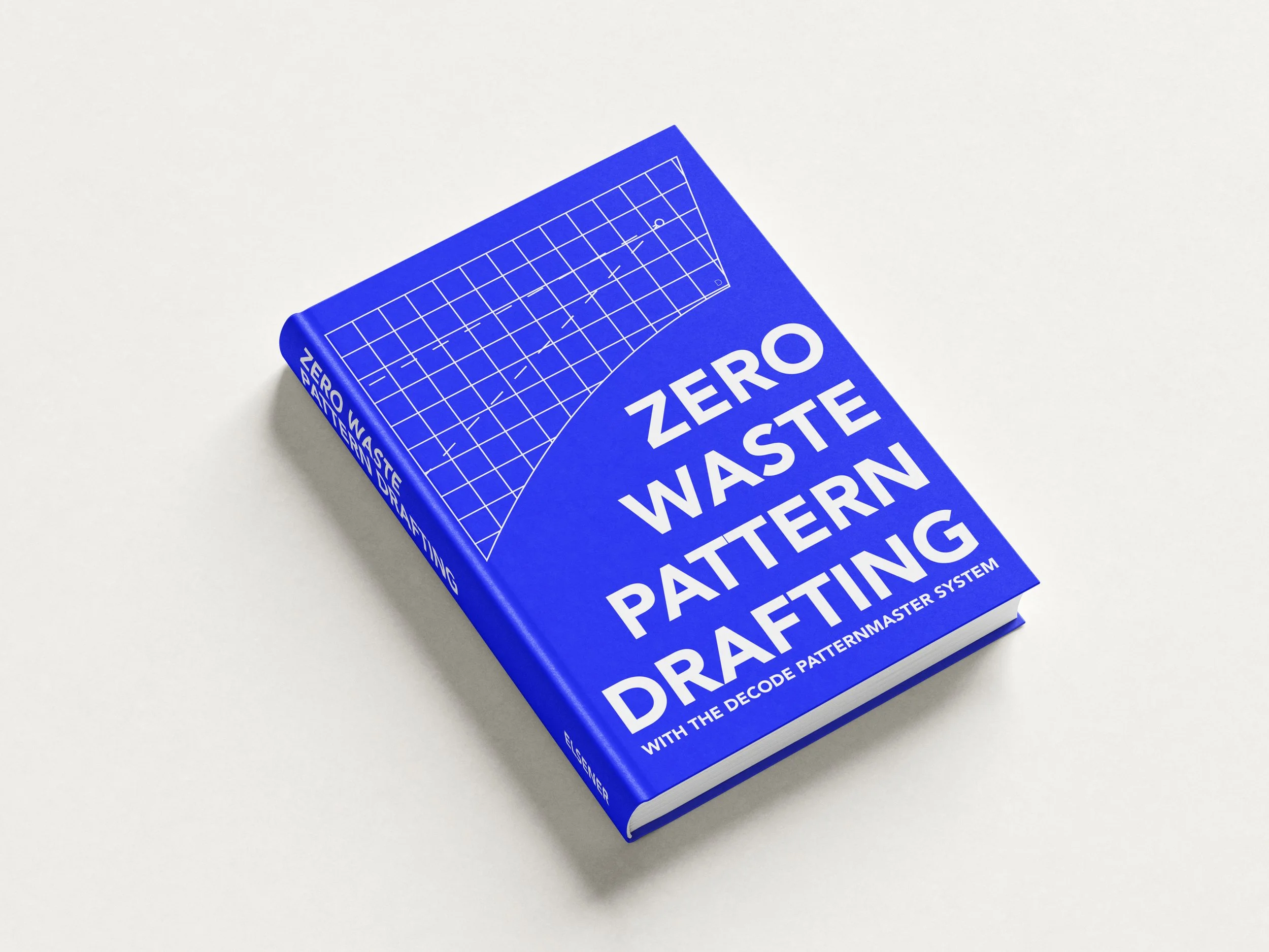 Blue book titled 'Zero Waste Pattern Drafting' with white text, lying on a white surface, showing part of the cover design.