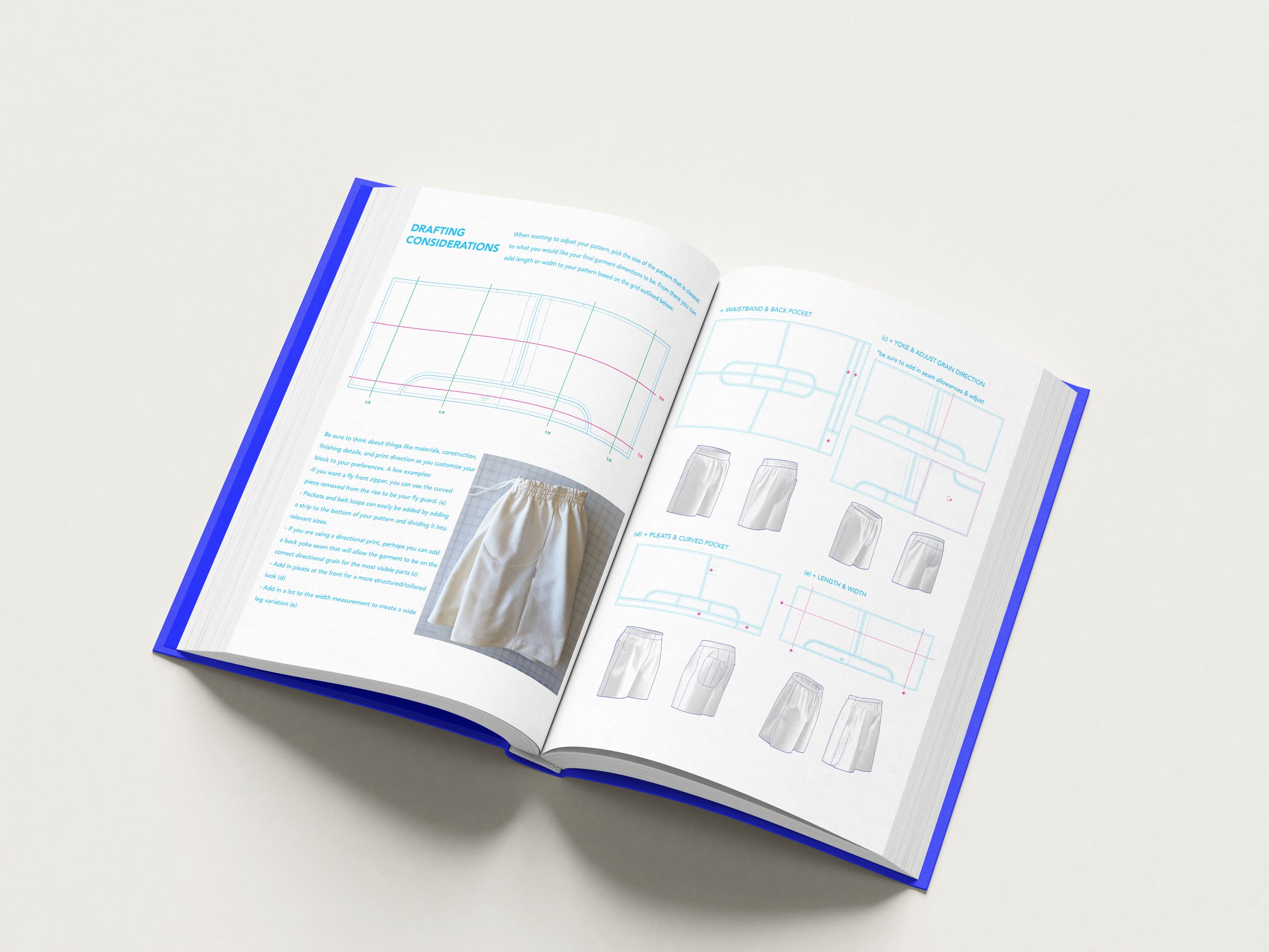 Open book showing design sketches, diagrams, and notes on drafting considerations for clothing or fabric patterns, with a blue cover.