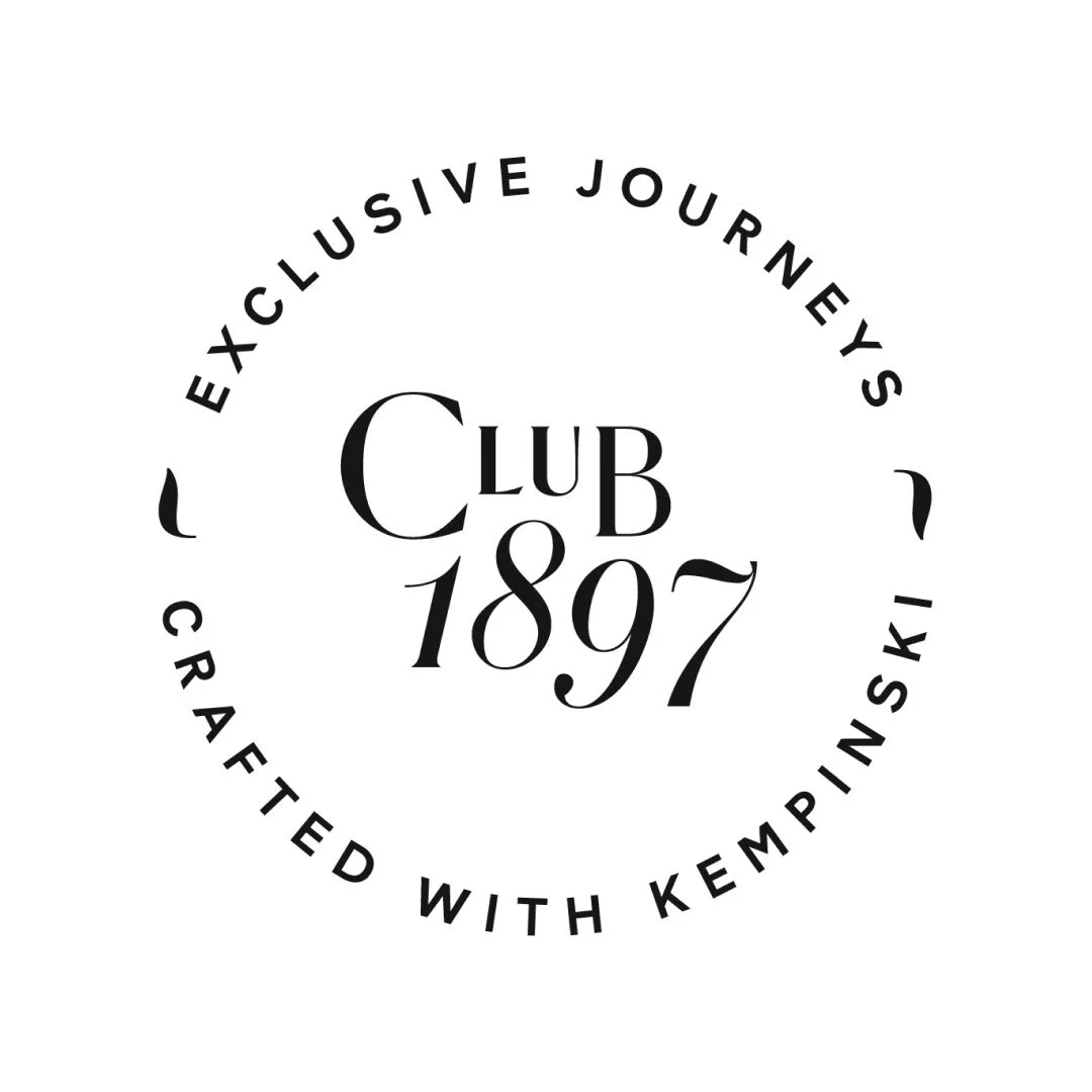 Logo for Club 1897, featuring circular text around the center with the words 'Exclusive Journey's Crafted with Kempinski' and 'Club 1897' in the middle.