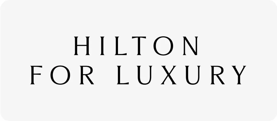 Logo with the text 'Hilton for Luxury' on a white background.