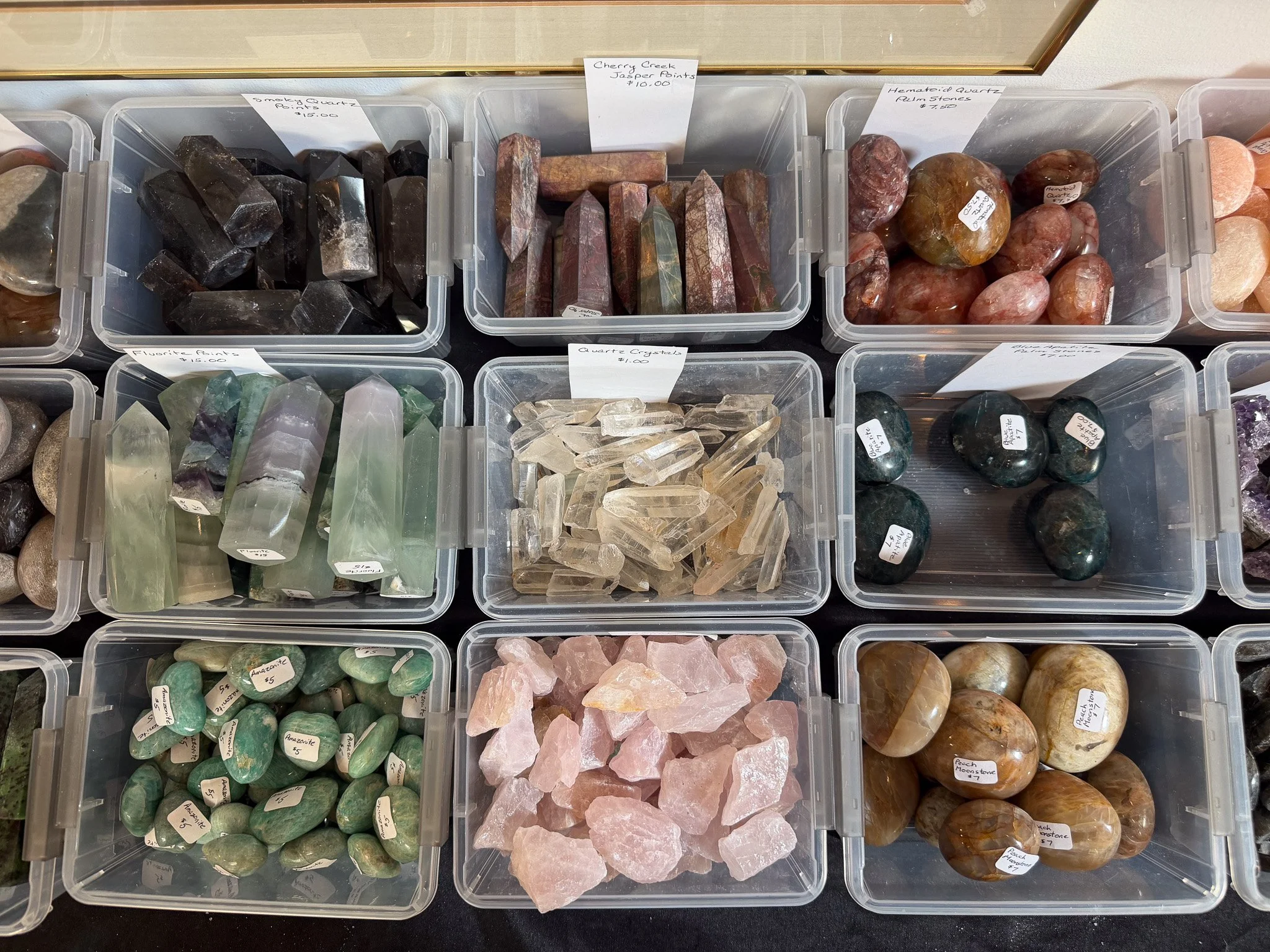 Plastic containers filled with a variety of crystals and rocks available at Evil Ed's Rock Shop