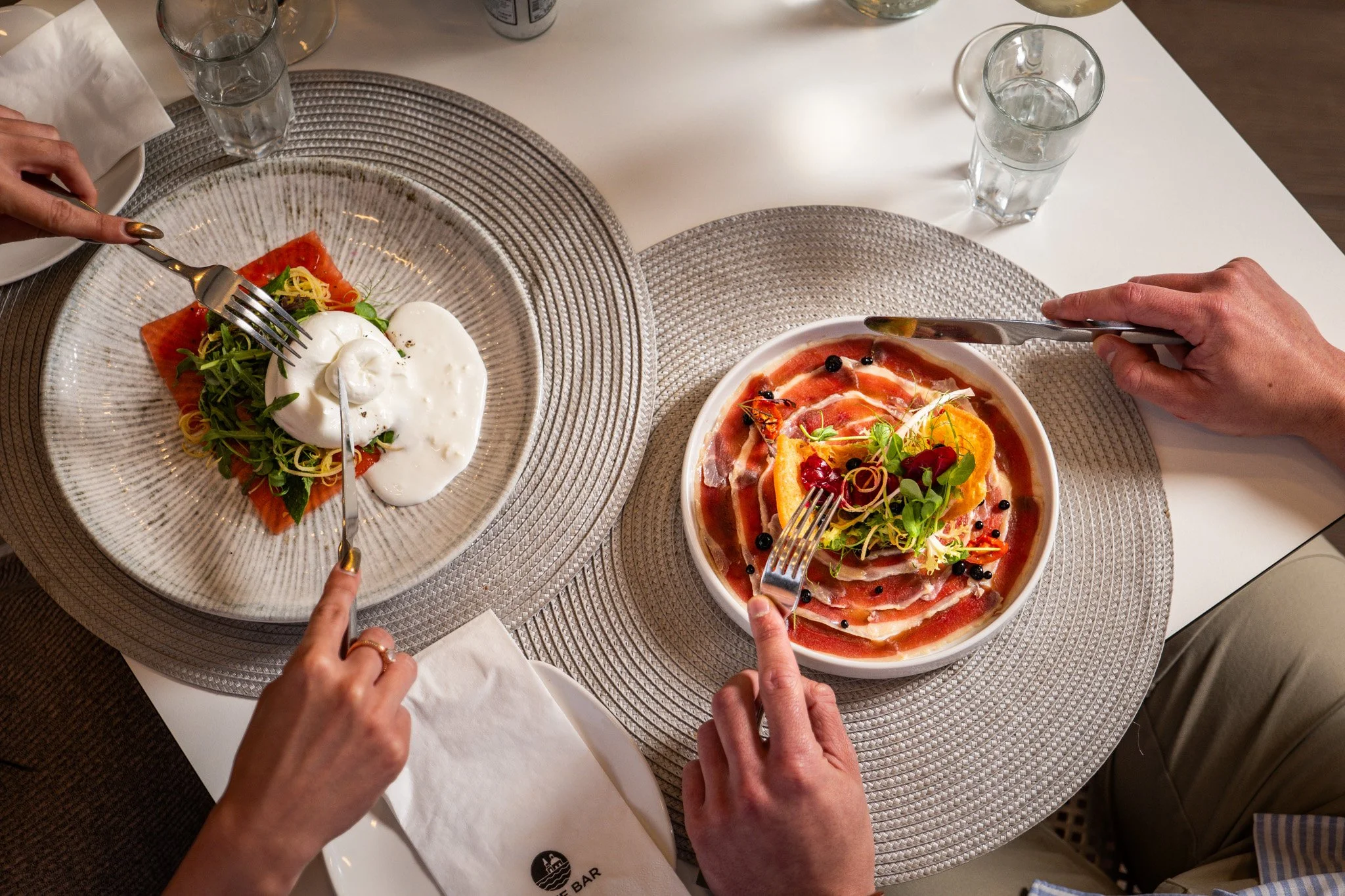 Commercial restaurant photography featuring elegantly plated gourmet dishes enjoyed by guests, creating engaging visual content for hospitality marketing in Malta.