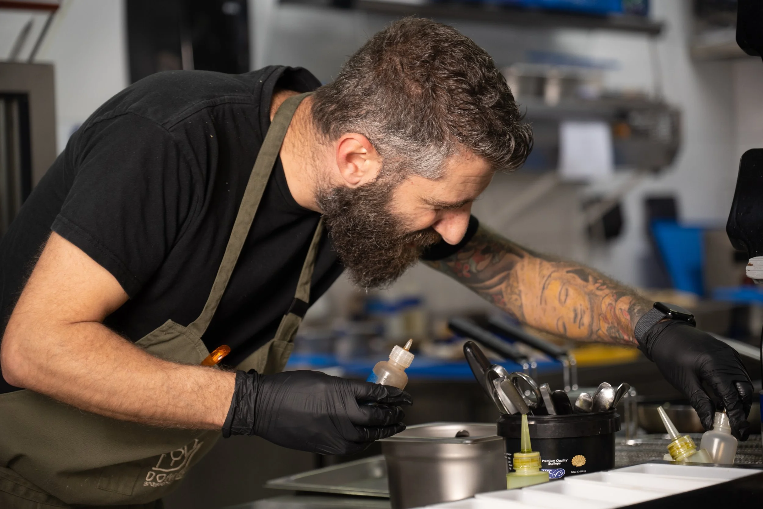 Professional chef photography capturing culinary craftsmanship and precision in a restaurant kitchen, showcasing authentic hospitality and commercial food preparation in Malta.