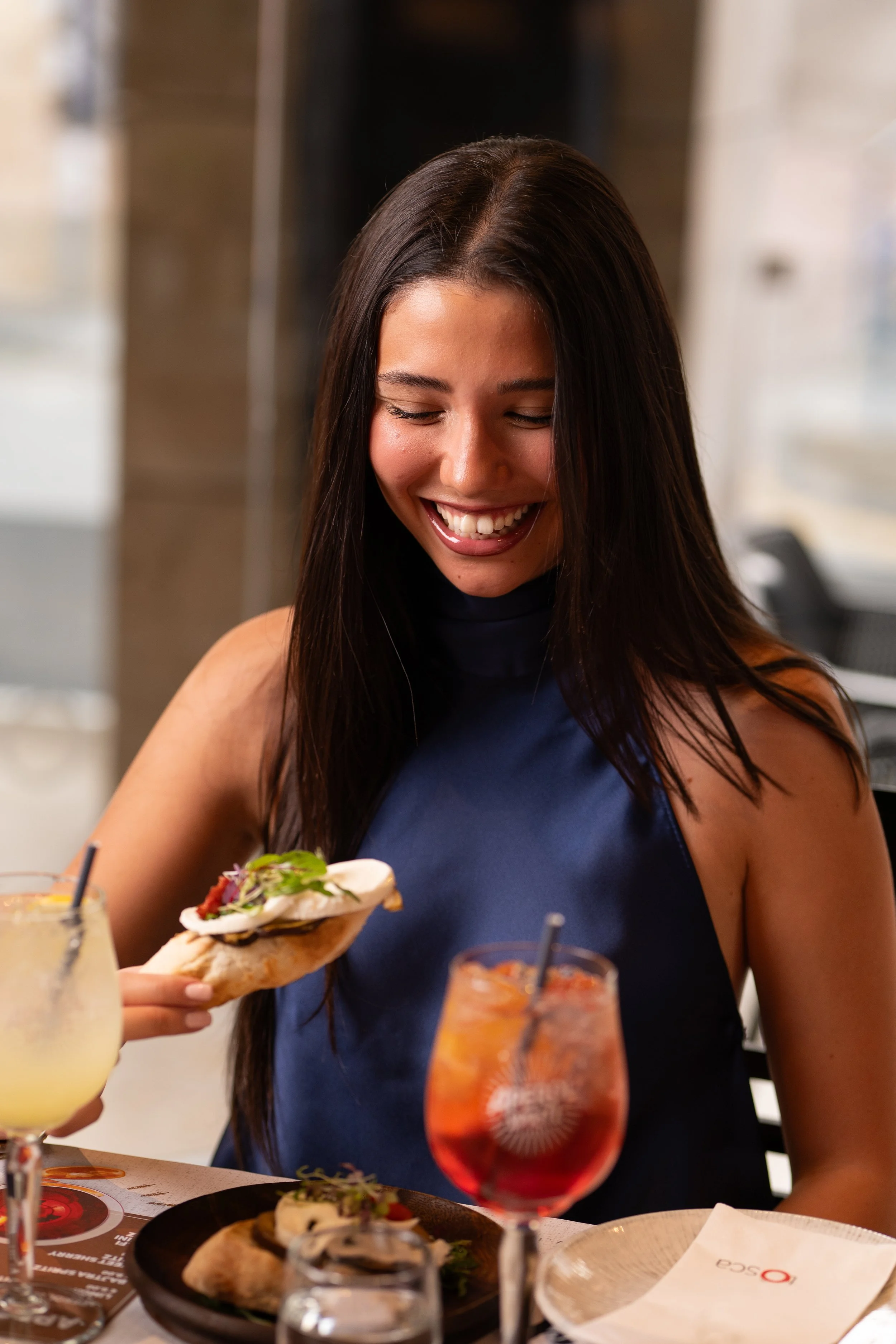 Restaurant lifestyle photography featuring a guest enjoying gourmet food and signature cocktails, created for hospitality marketing and social media in Malta.
